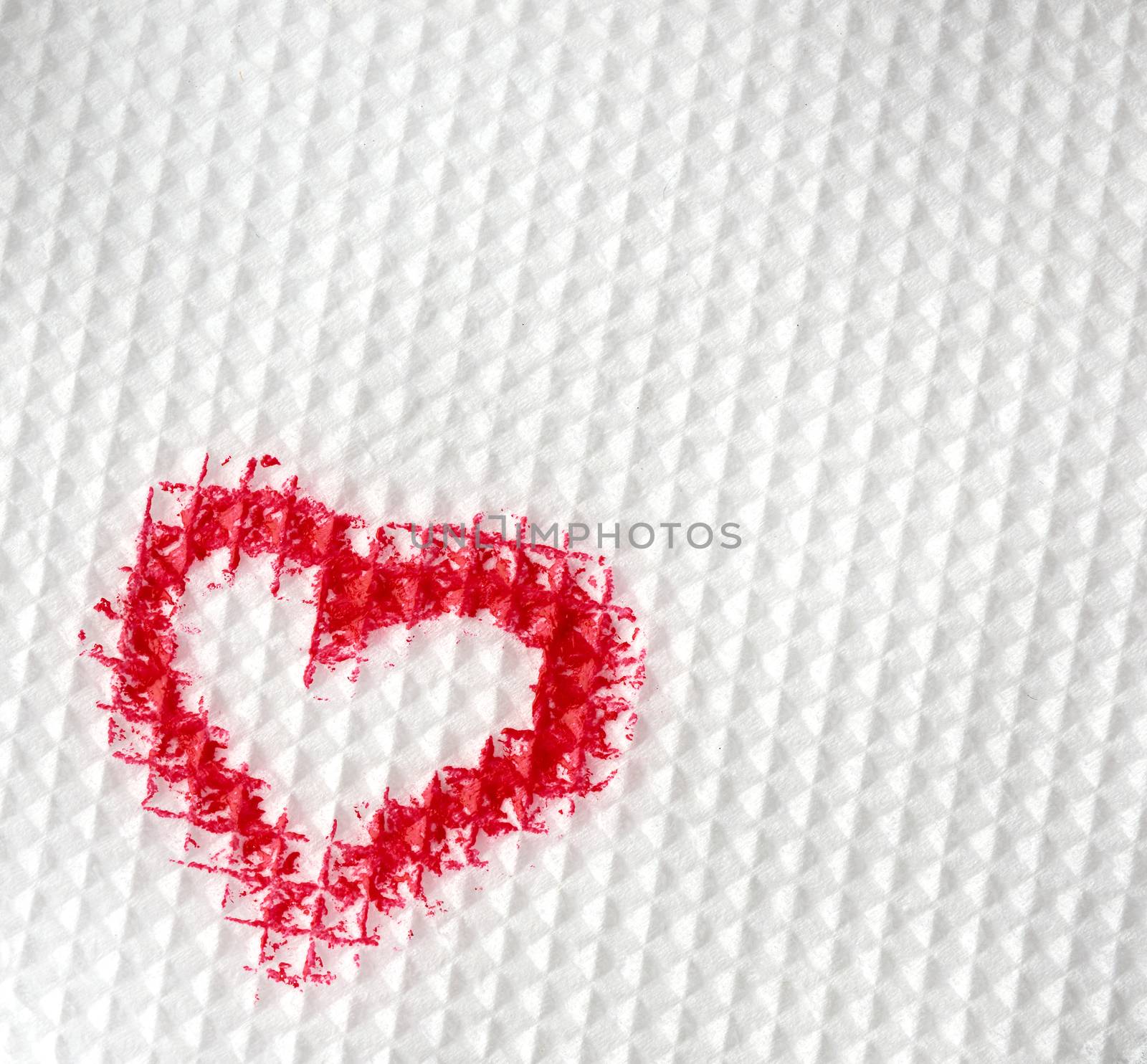 painted heart with red lipstick on a white paper napkin by ndanko