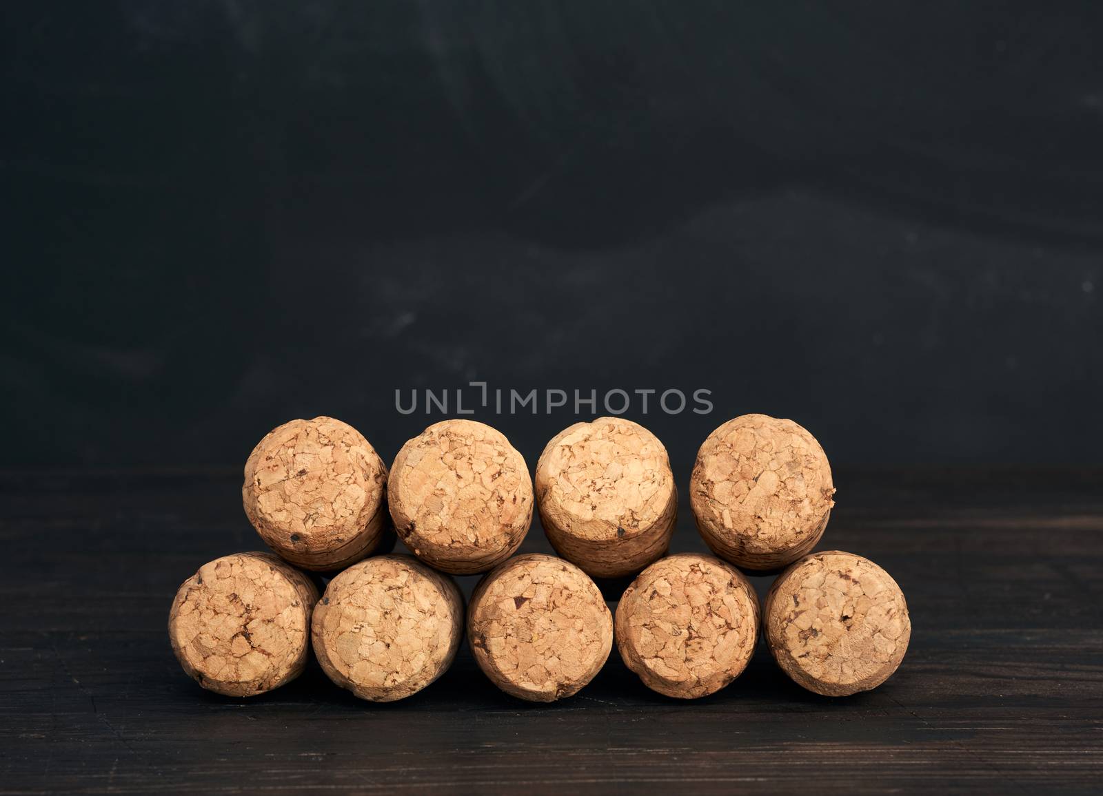 stack of corks for glass wine and champagne bottles on wooden ba by ndanko