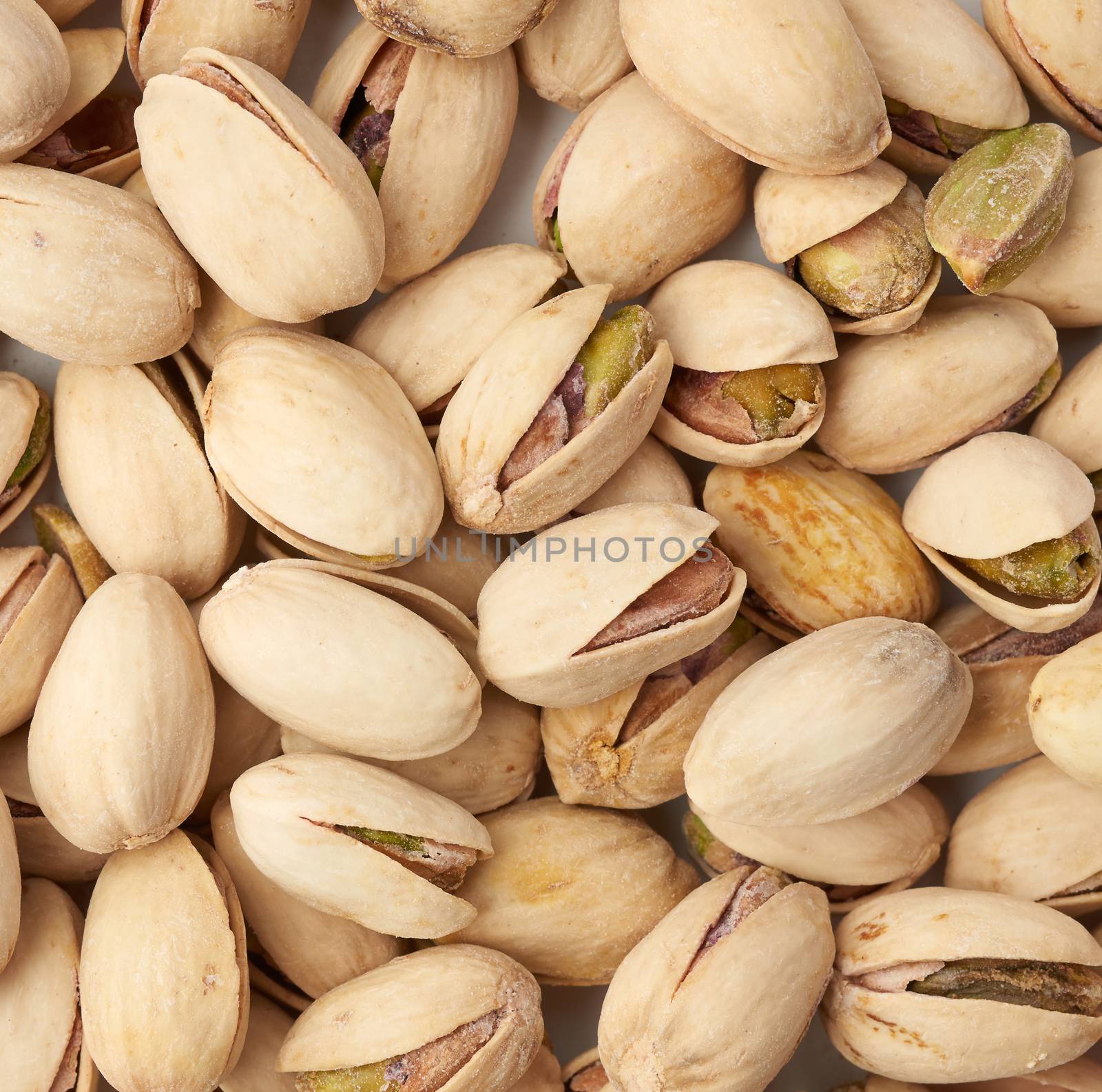 bunch of open pistachios with salt, close up, top view