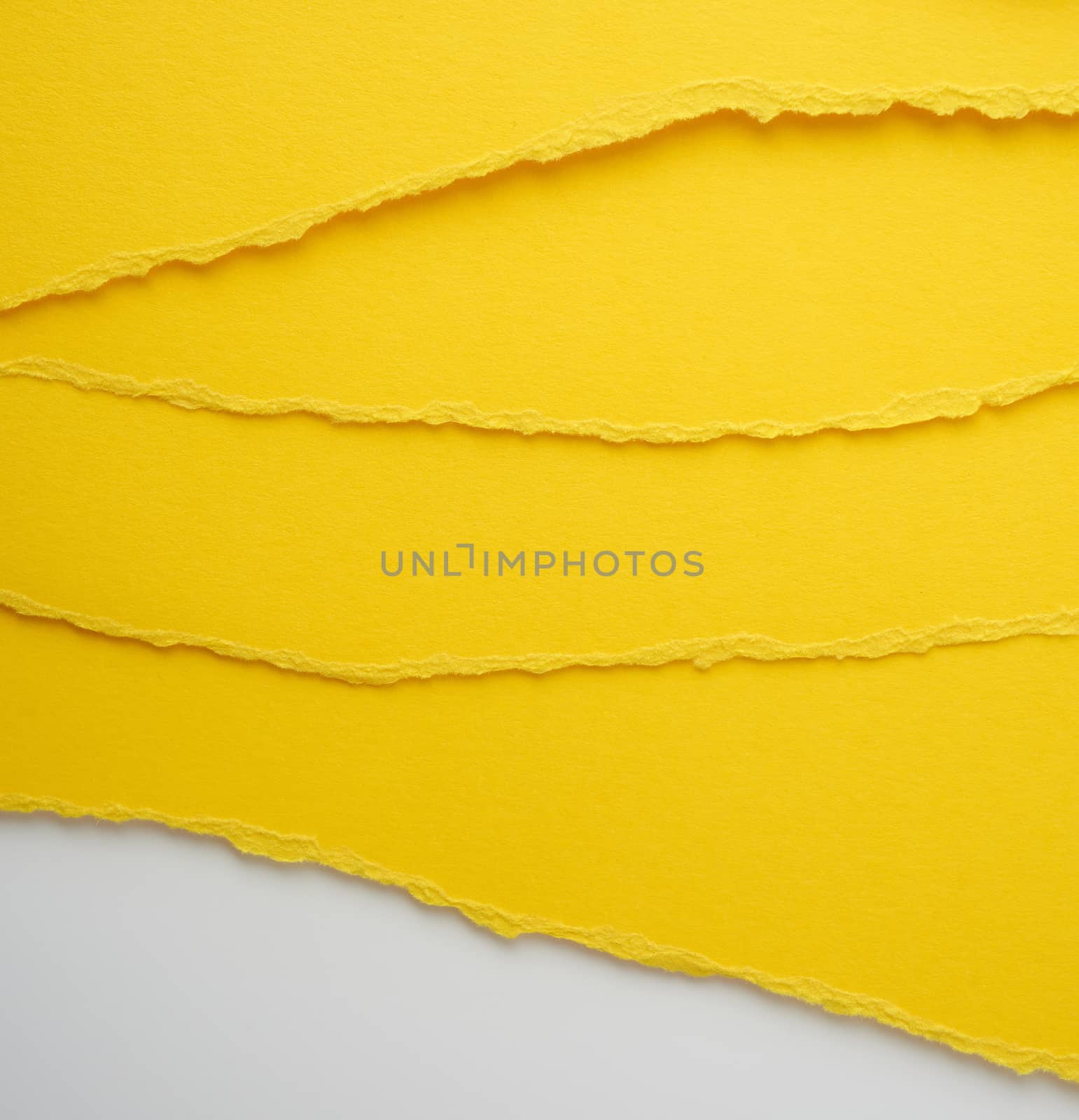 background of layered yellow torn paper with a shadow, backdrop  by ndanko