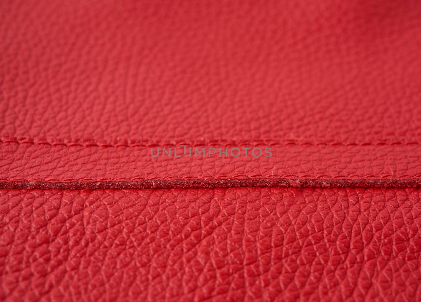 natural bright red cowhide texture, full frame, scarlet color, close up