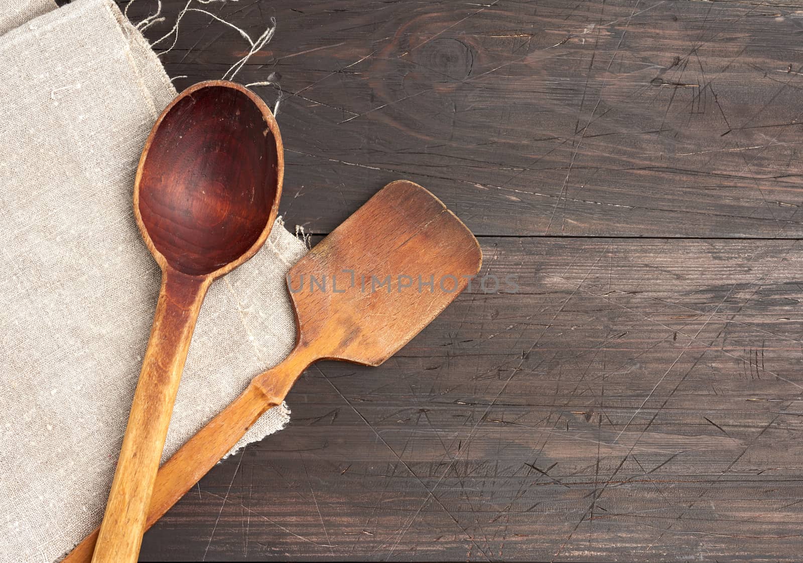 empty wooden spoon and spatula on a brown wooden background from by ndanko