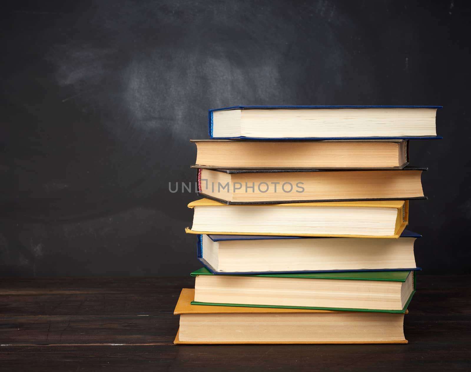 stack of various hardback books on the background of an empty bl by ndanko