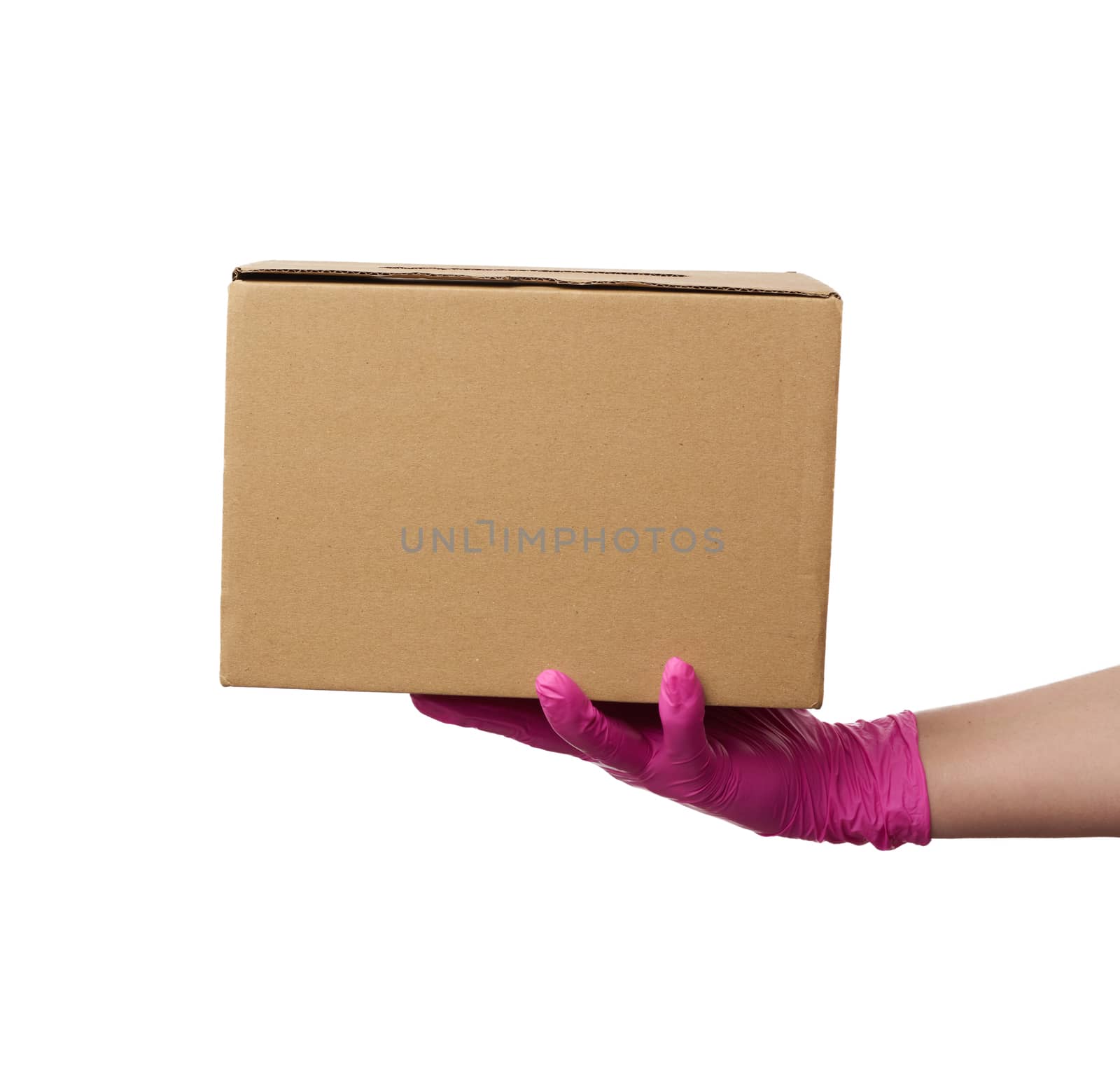 female hand in pink latex glove holds a cardboard box of brown kraft paper on a white background, safe and contactless delivery of on-line orders during epidemics