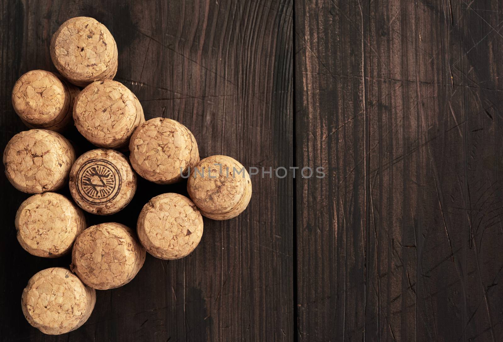 stack of corks for glass wine and champagne bottles on wooden background, copy space, top view