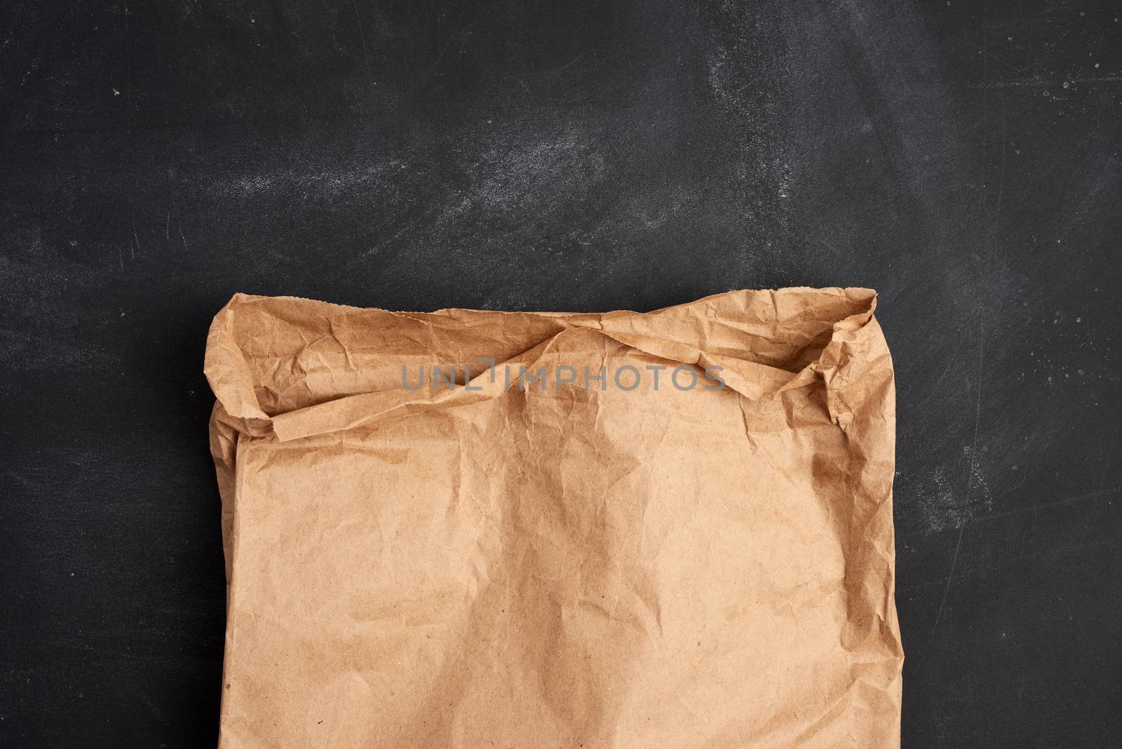 brown paper bag on a black background, top view by ndanko