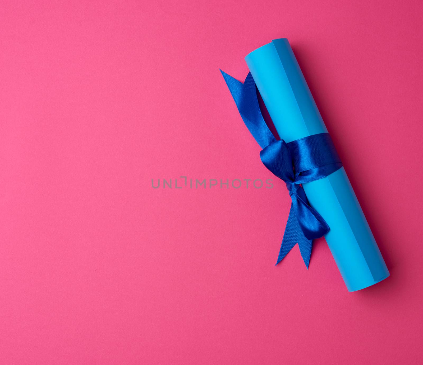 roll of blue paper tied with a silk blue ribbon by ndanko