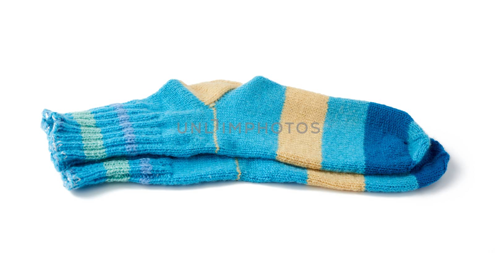 pair of striped handmade knitted warm socks made of sheep’s wool yarn, blue clothing is isolated on a white background