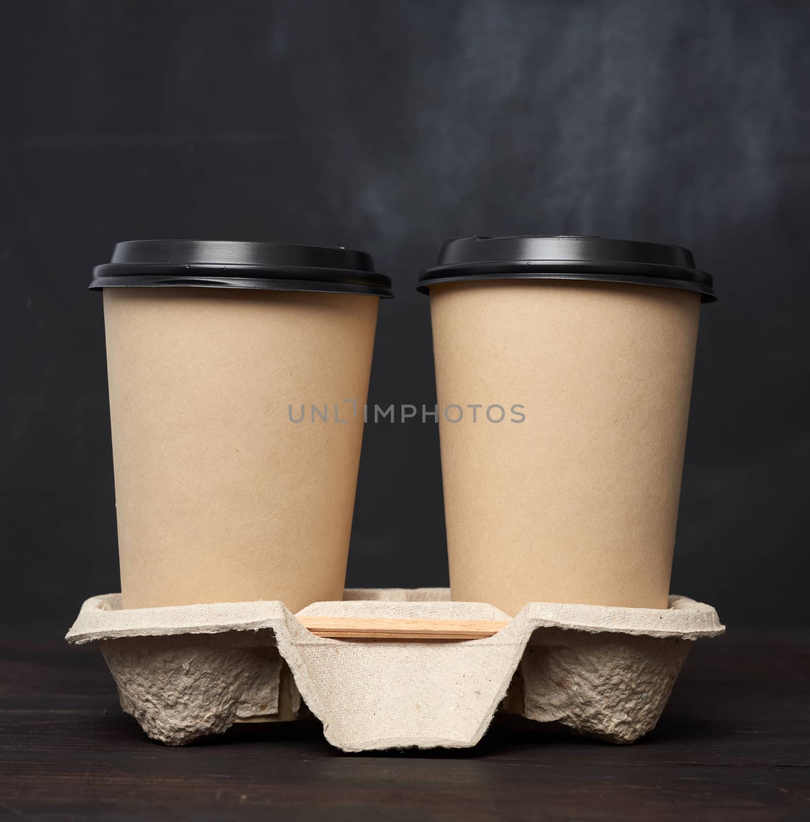 two brown paper disposable cups with a plastic lid stand in the by ndanko