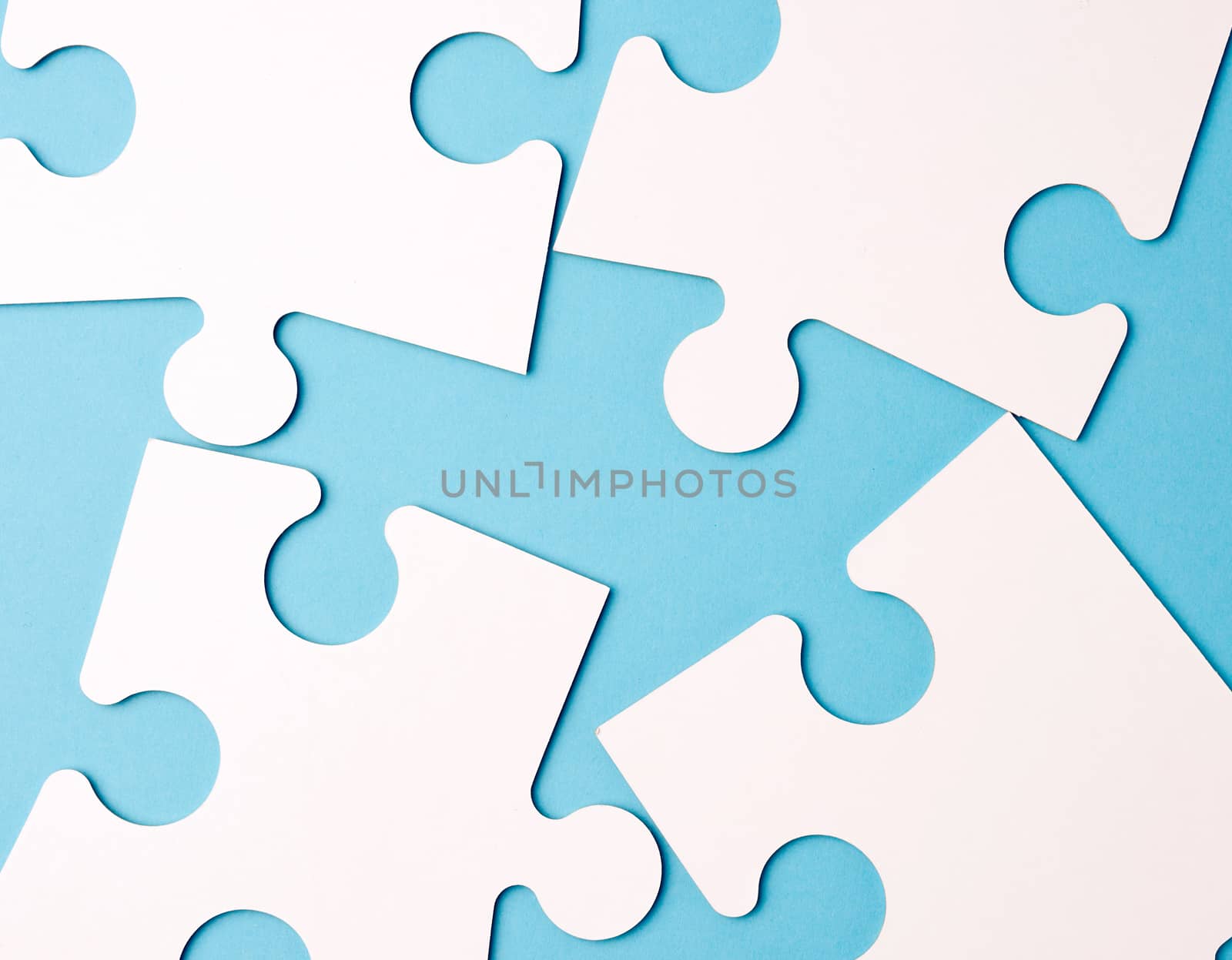 empty white big puzzles on a blue background. Concept in busines by ndanko