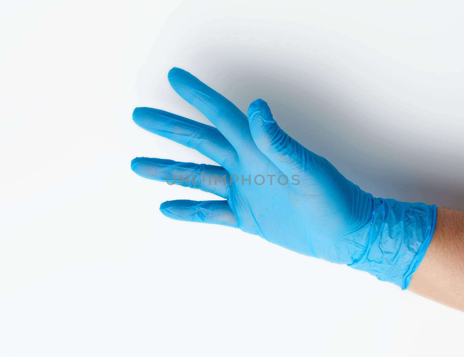 blue medical glove is worn on the arm, part of the body on a white background, close up