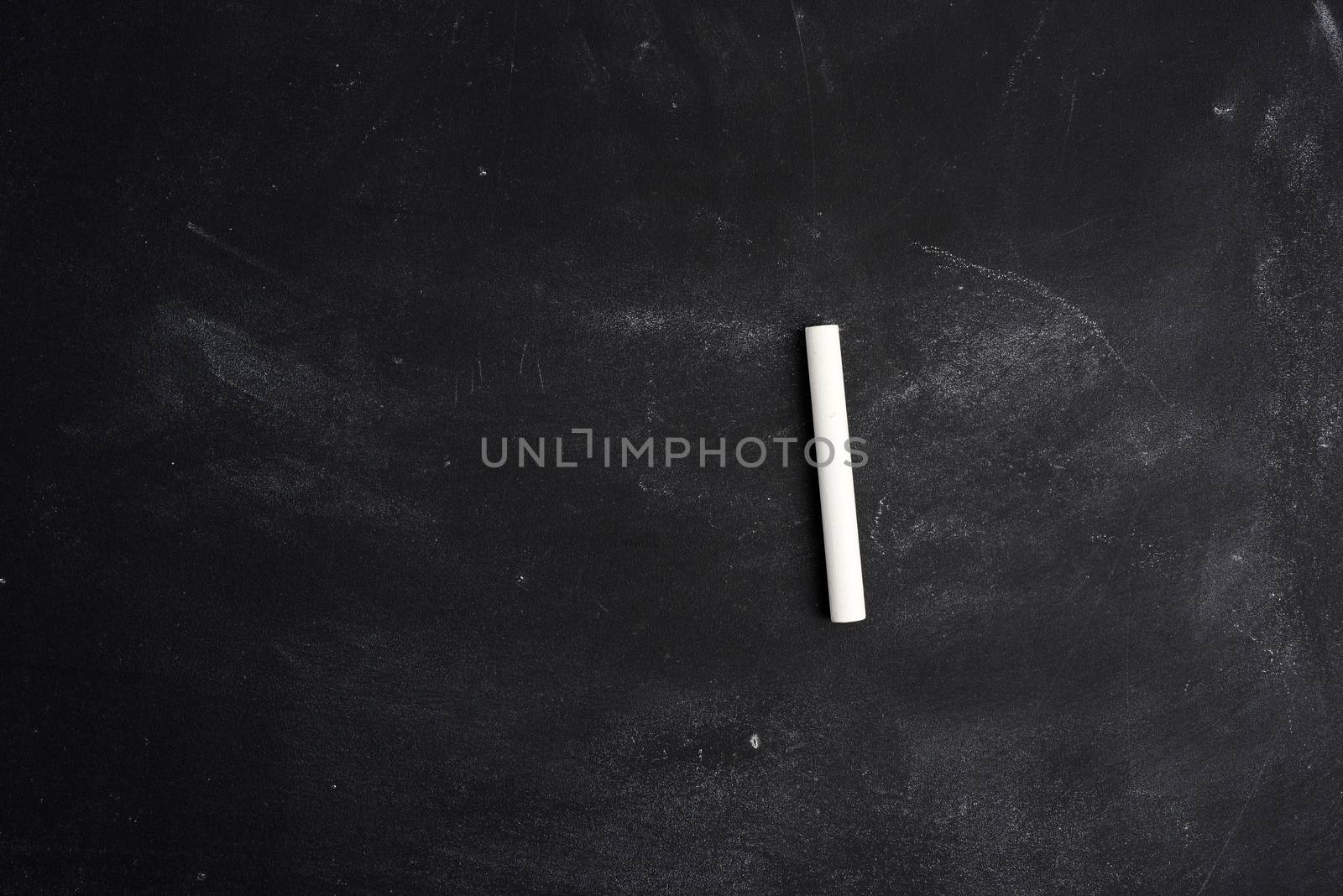 empty black chalk board and white chalk sticks by ndanko