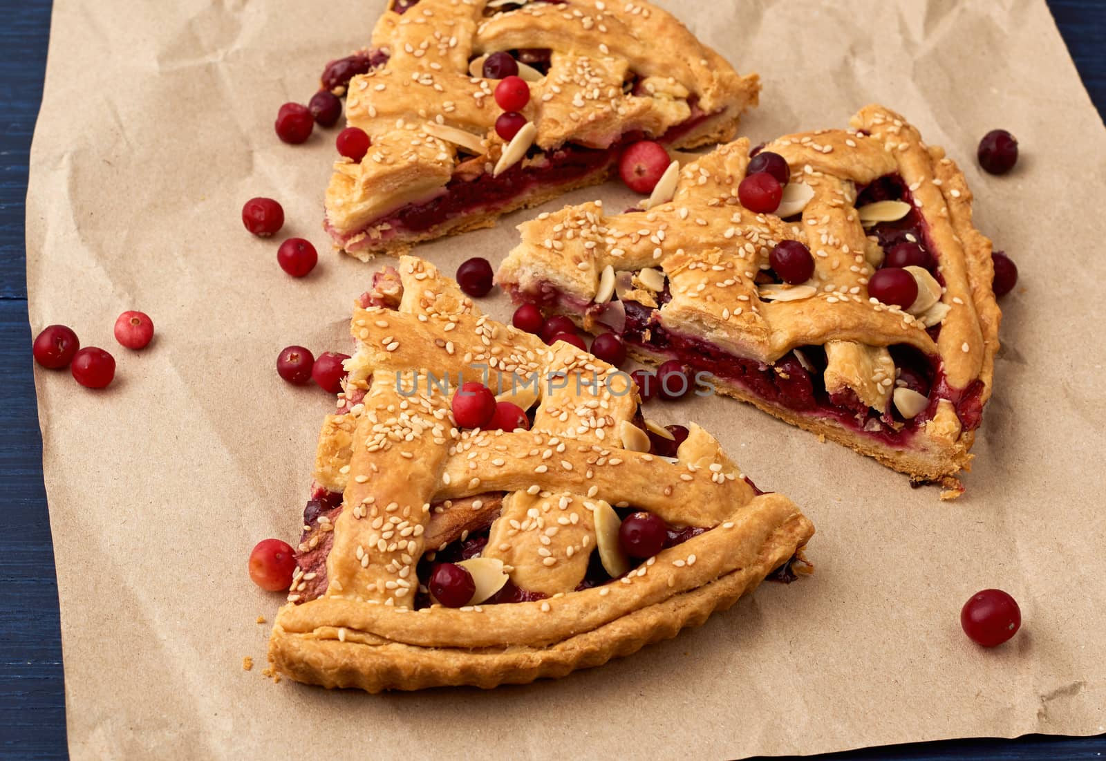 slice pie cranberry. Blue wooden background. Delicious fruit cake.