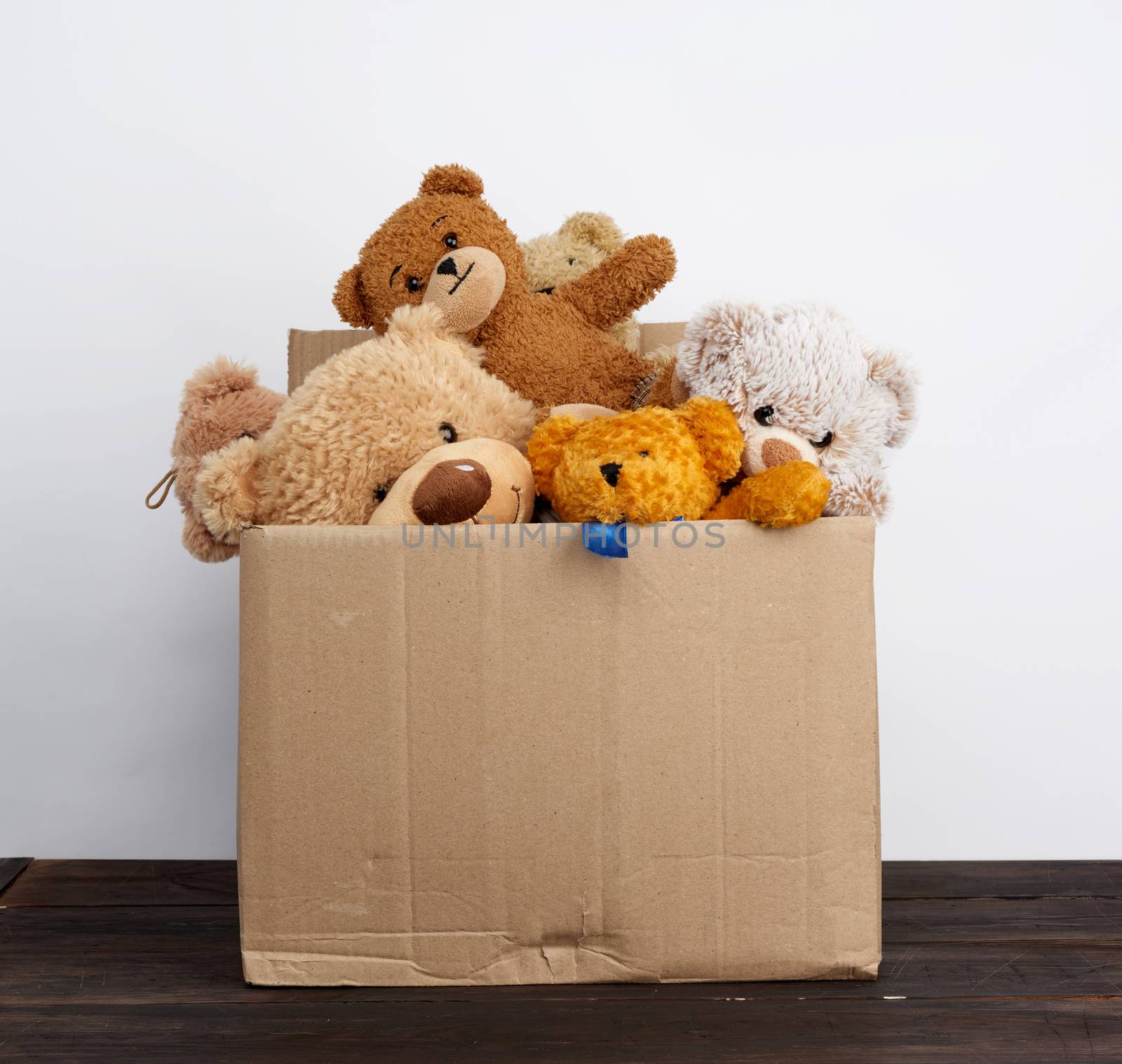 brown cardboard box filled with soft toys by ndanko