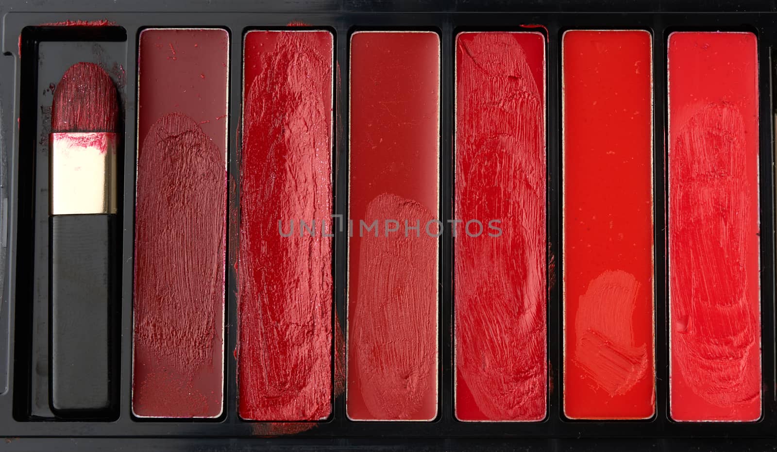 used palette with different shades of thick lipstick by ndanko