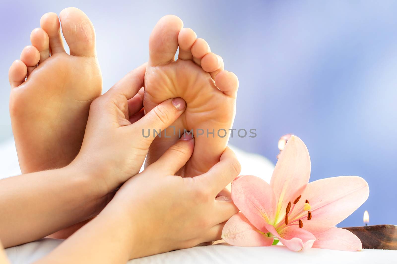 Close up reflexology massage on feet. by karelnoppe
