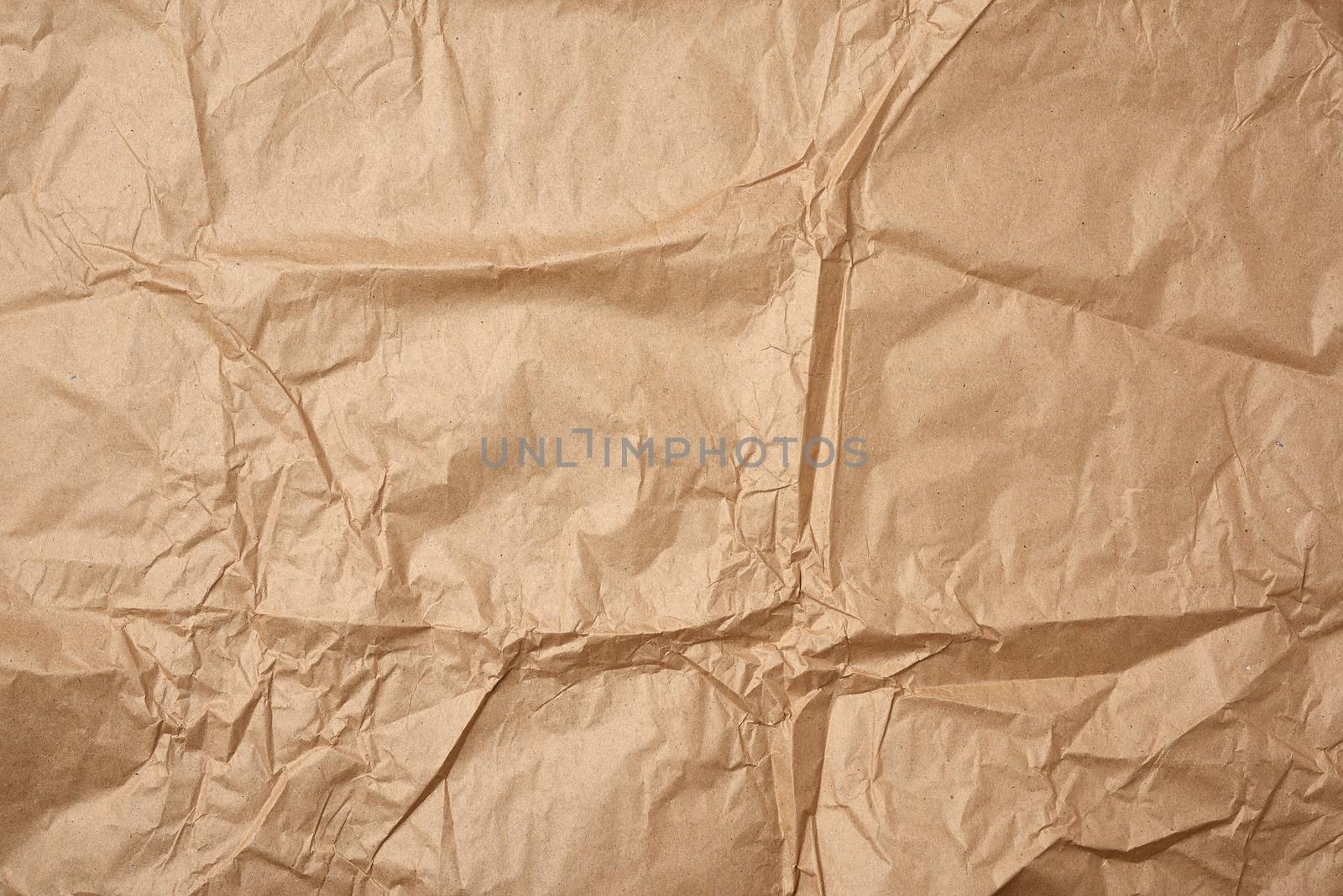 crumpled blank sheet of brown wrapping kraft paper by ndanko