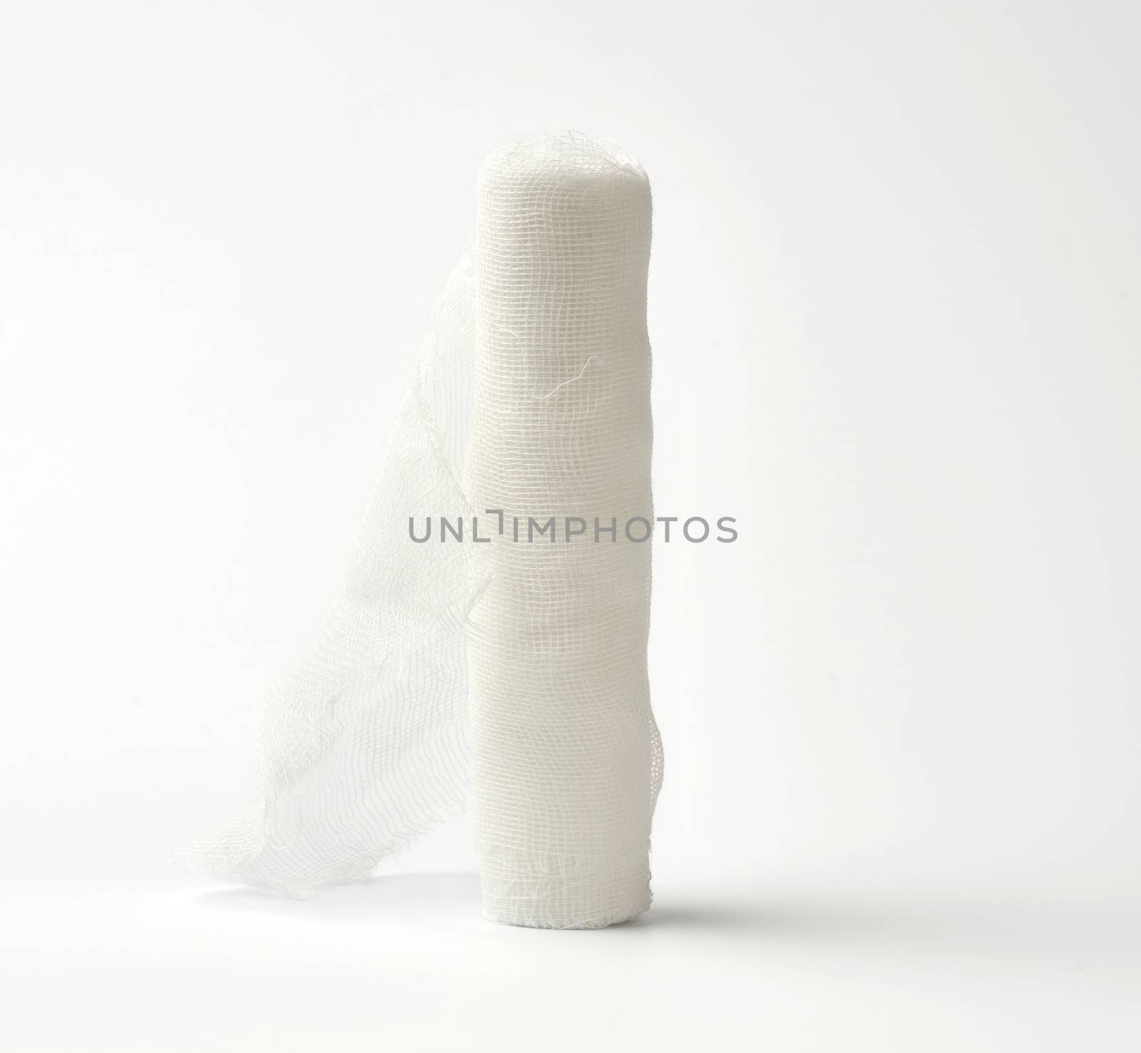 roll of white gauze bandage on a white background by ndanko