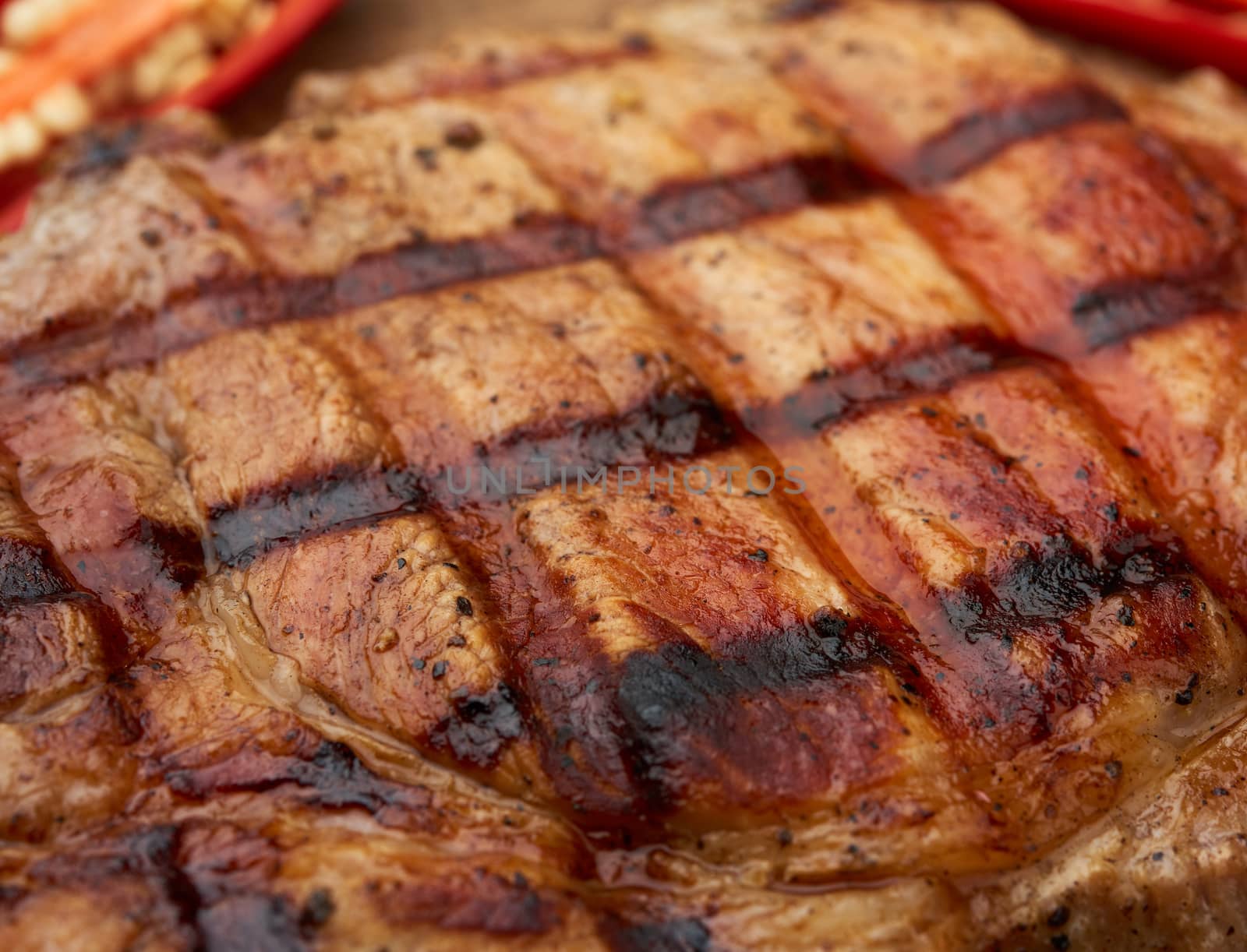 texture of grilled on the grill a piece of pork meat on the rib, macro