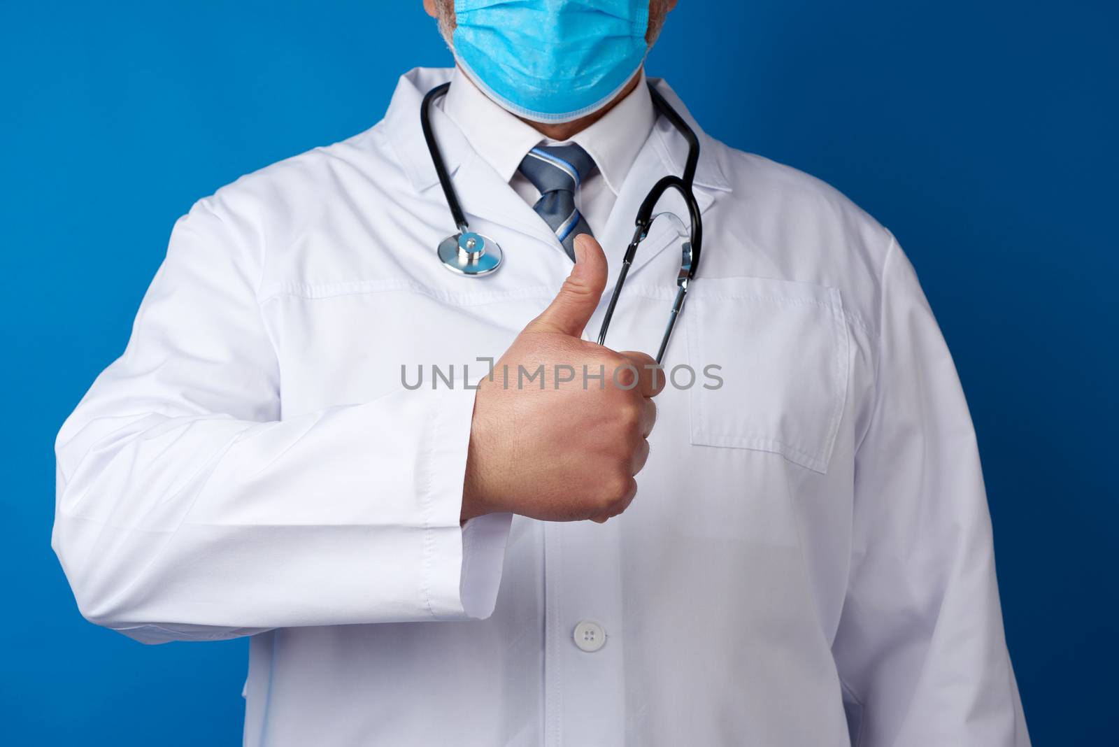 doctor in white coat shows hand gesture like, concept of approval and consent, blue background