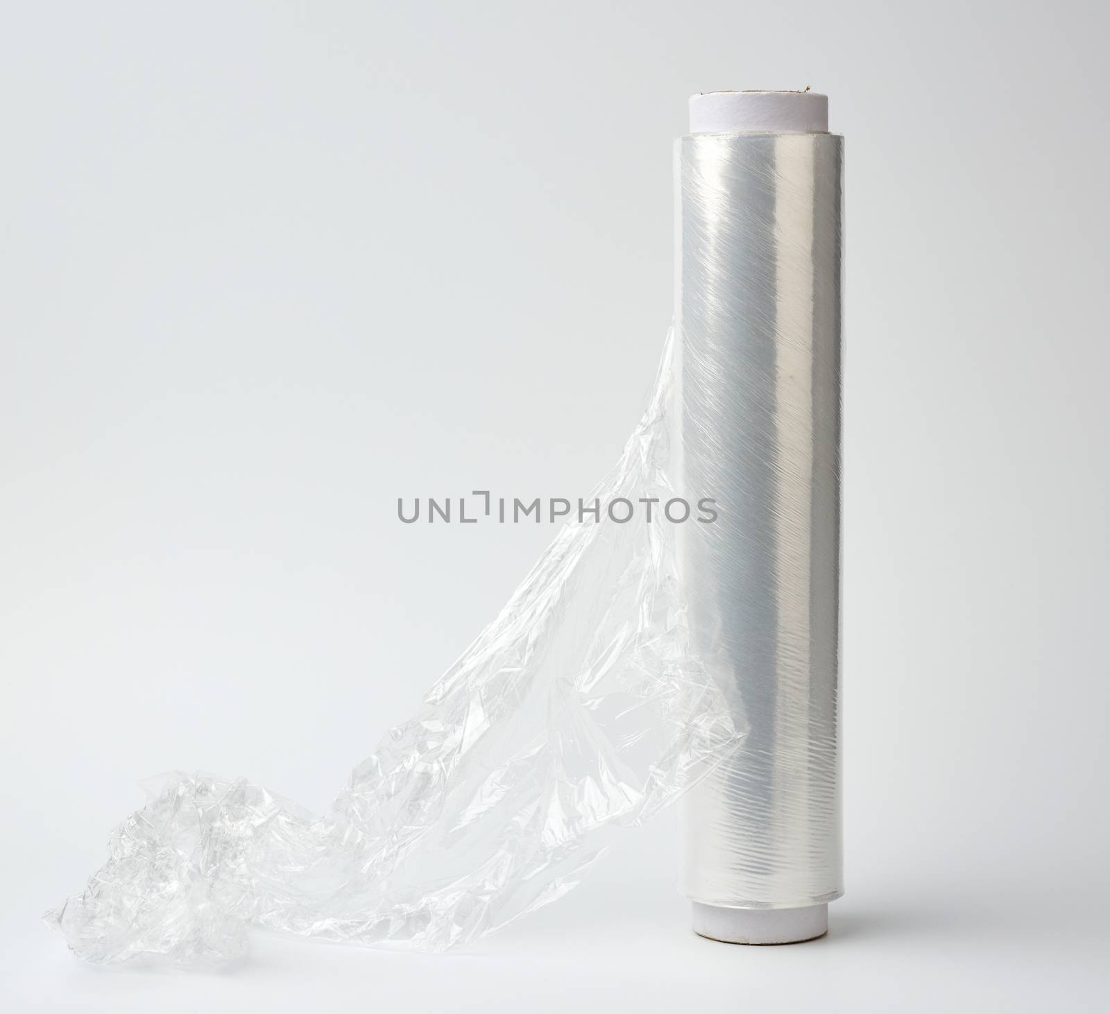 big roll of wound white transparent film for wrapping food, white background, close up