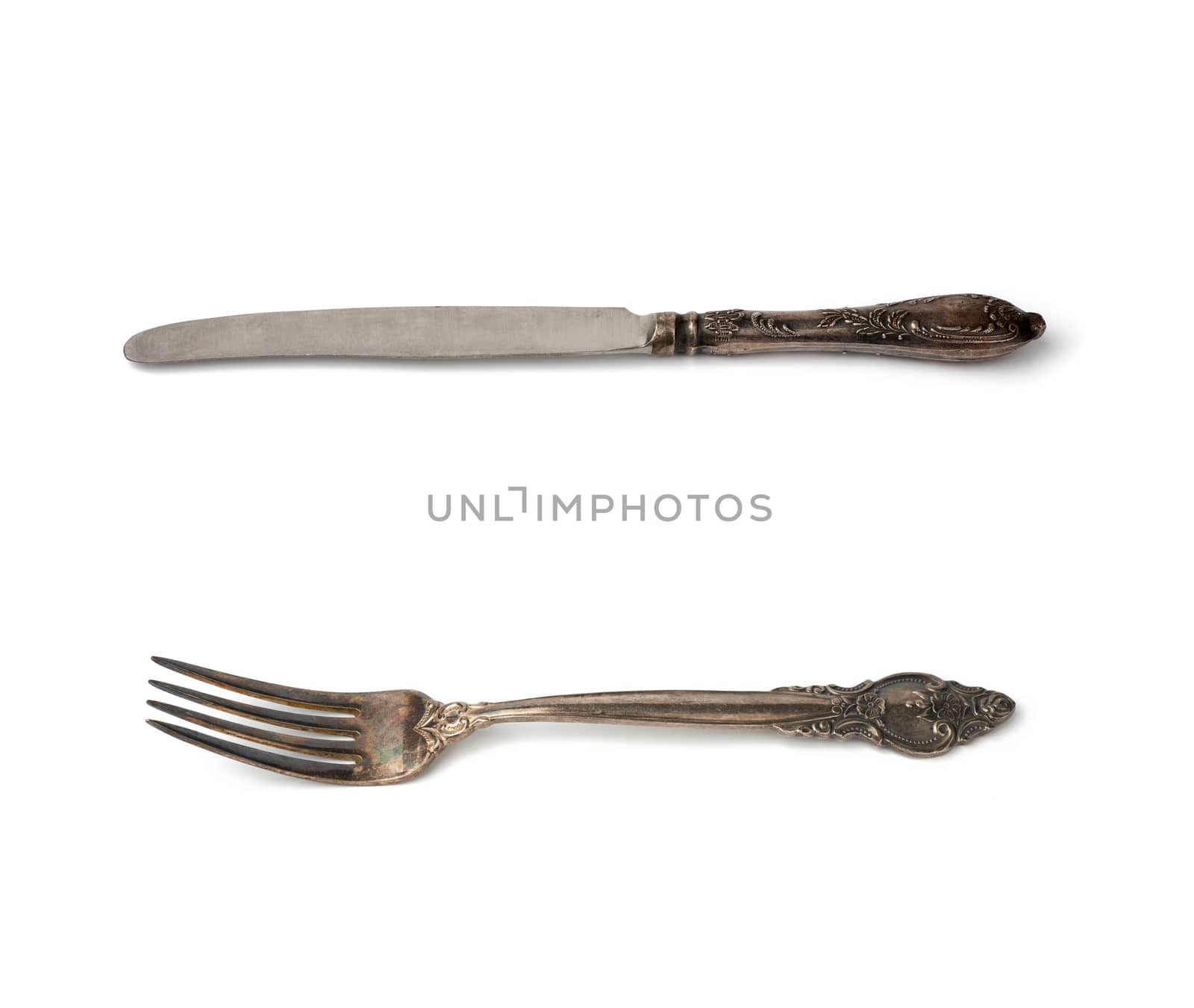 metal table vintage knife and fork isolated on white background, close up