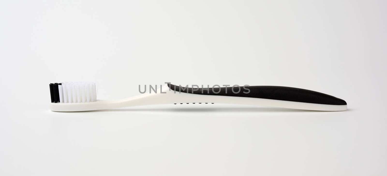 black plastic toothbrush for cleaning the oral cavity, object on a white background