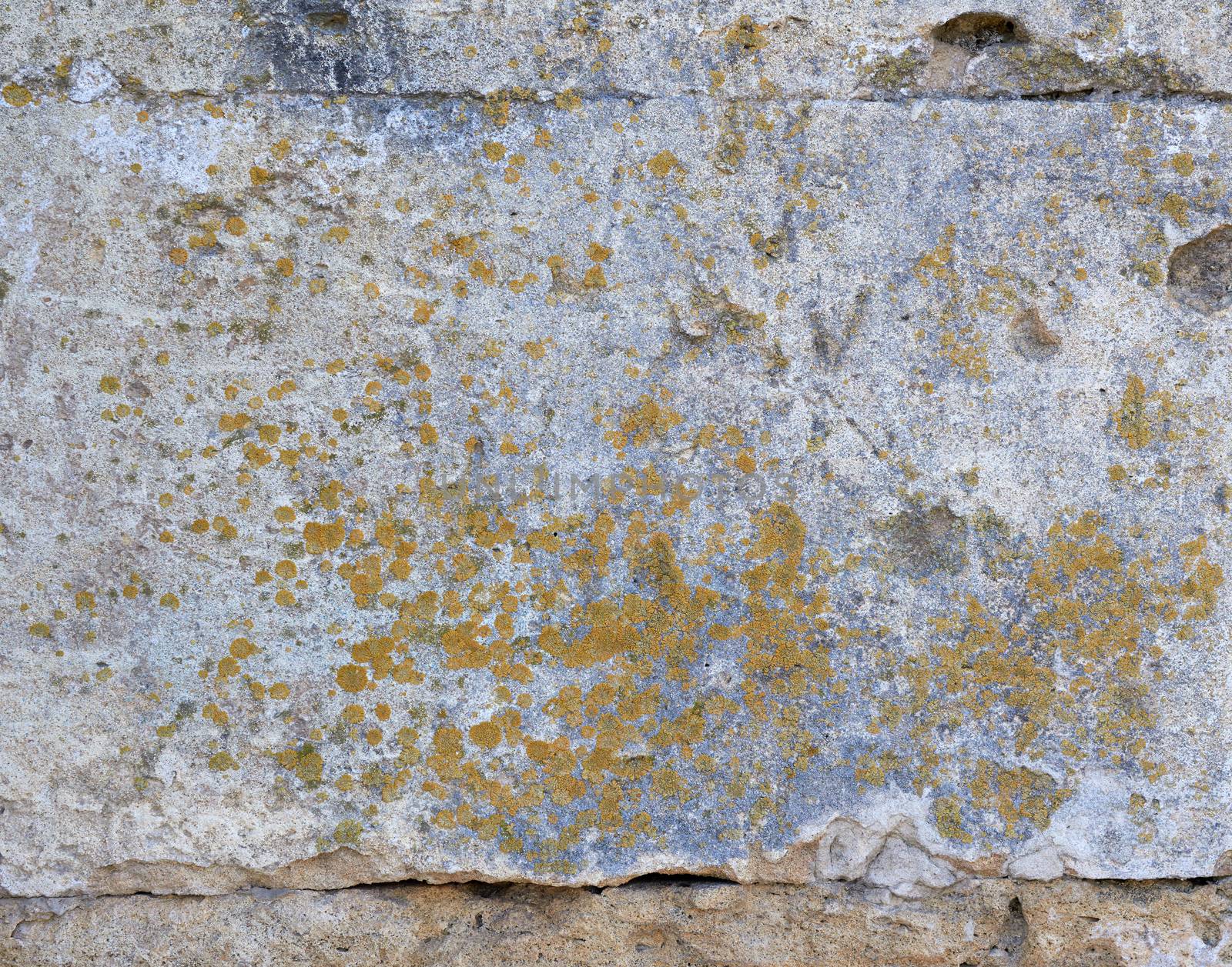 wall of yellow rectangular stones with cement, fragment of ancient architecture, full frame, close up