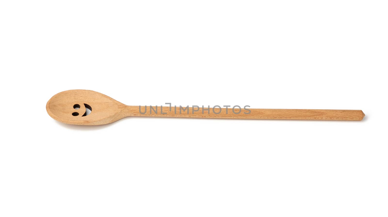 wooden spoon with a long handle and a carved face on the surface, utensils isolated on a white background