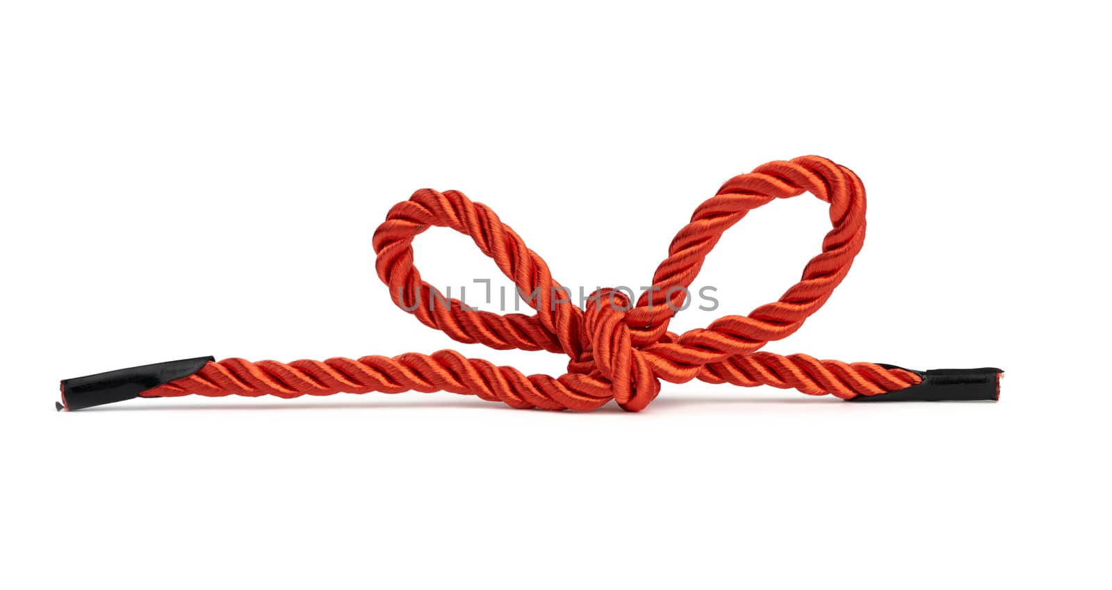 red twisted lace from silk threads is isolated on a white background and tied in a bow, close up