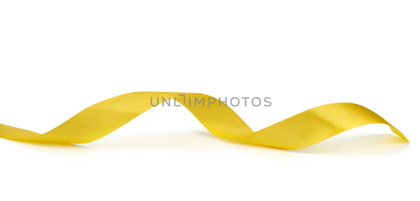 twisted yellow silk ribbon isolated on white background, designer element for gift decor, close up