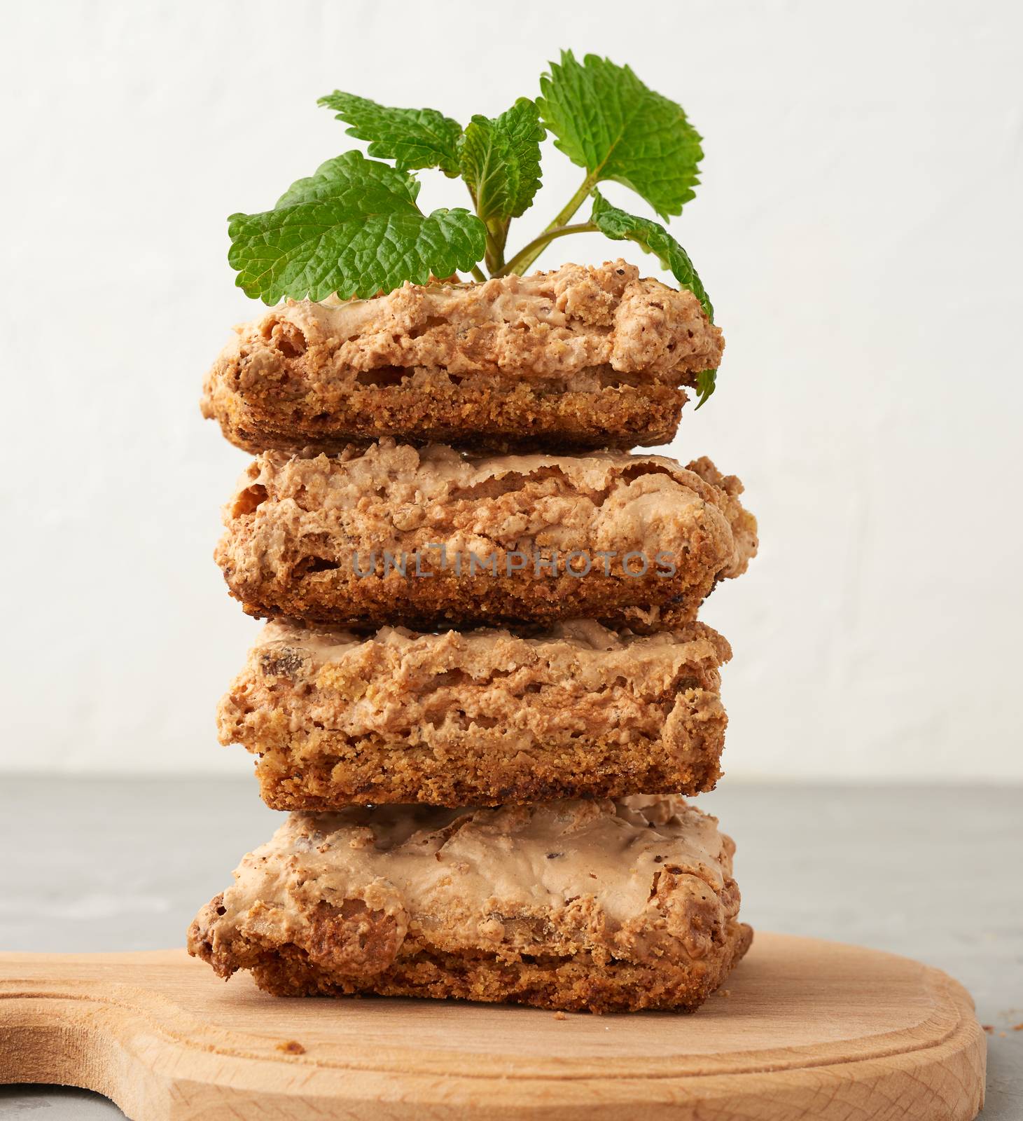 stack of baked Krakow meringue cookies on a wooden board, delicious dessert of whipped egg whites and almond flour