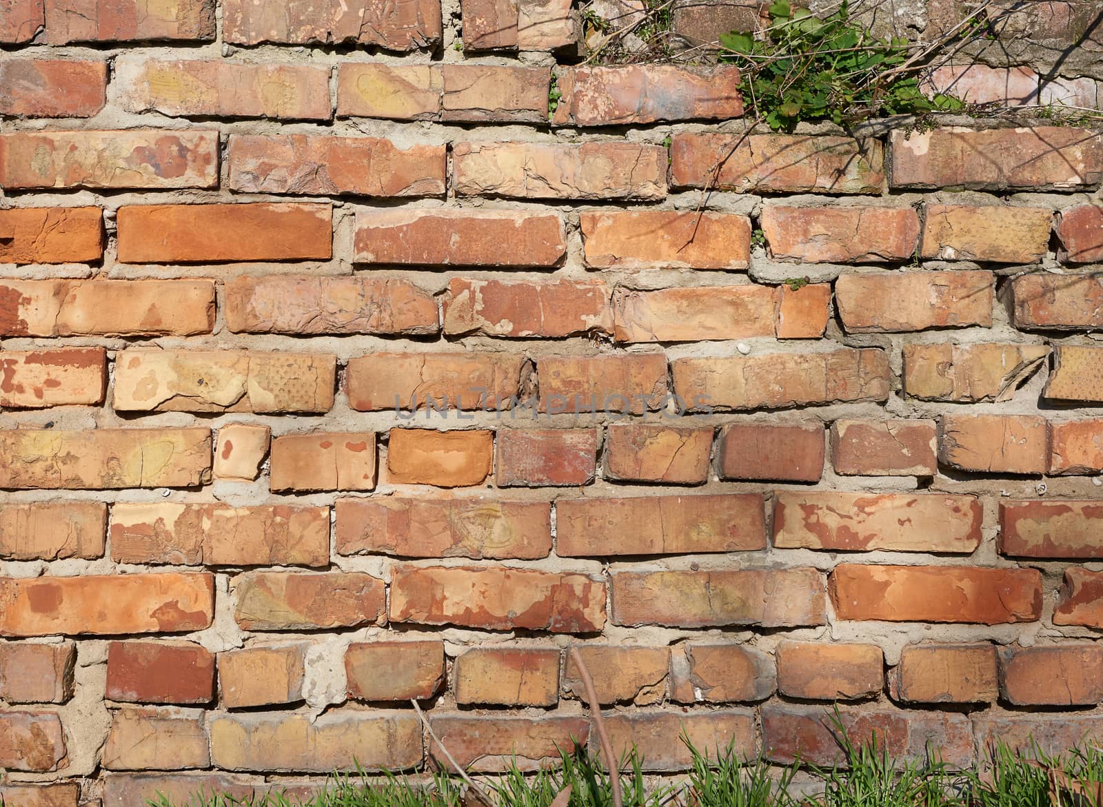 red brick wall with cement, fragment of architecture, outdoors 
