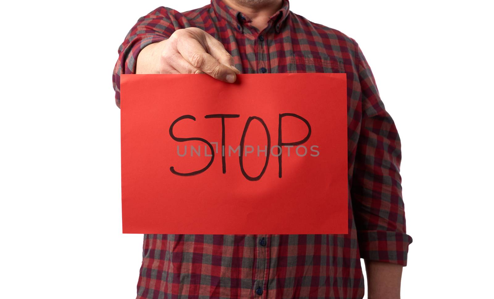 adult man in a red checkered crumpled shirt holds a red sheet of paper with the inscription stop, concept stop panic