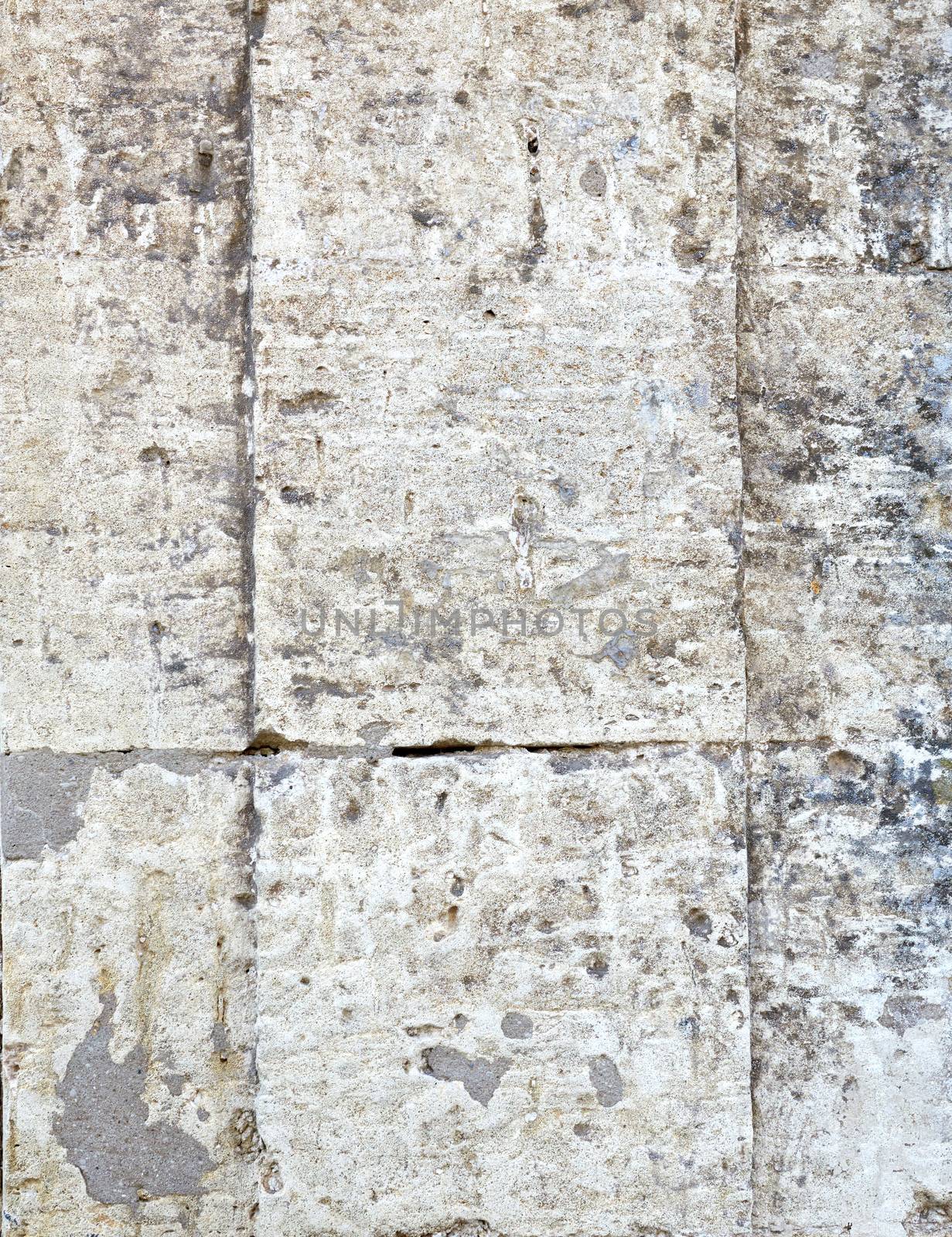 wall of yellow rectangular stones with cement, fragment of ancient architecture, full frame, close up