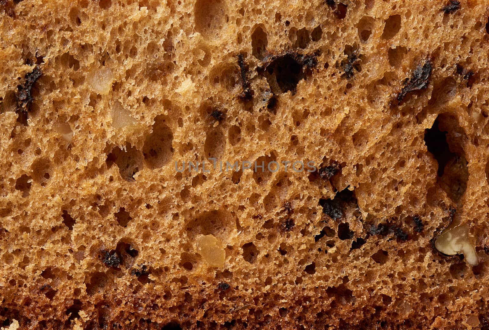 brown texture of baked sponge cake with nuts, baking structure, full frame