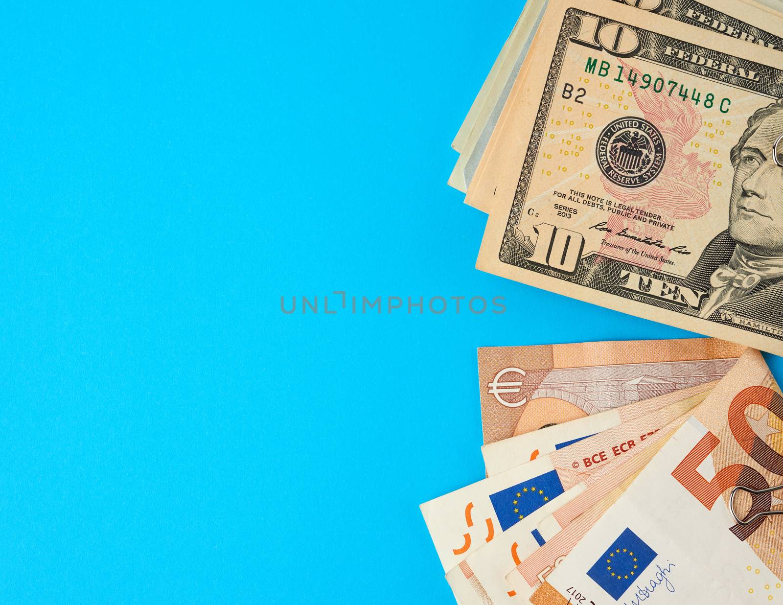 EU paper money euro and american dollars on blue background, concept of wealth, investment exchange, crisis, copy space