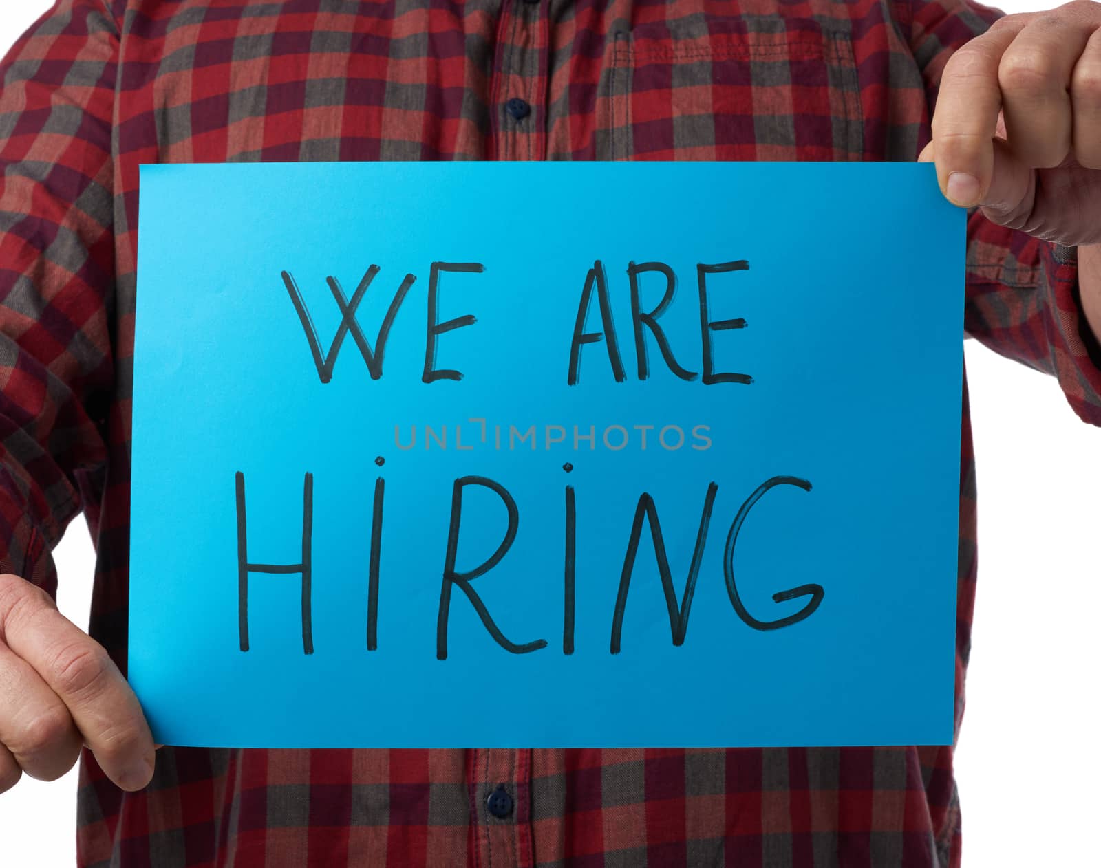 blue piece of paper with the inscription we are hiring, concept of unemployment against the backdrop of the global crisis, fired employee