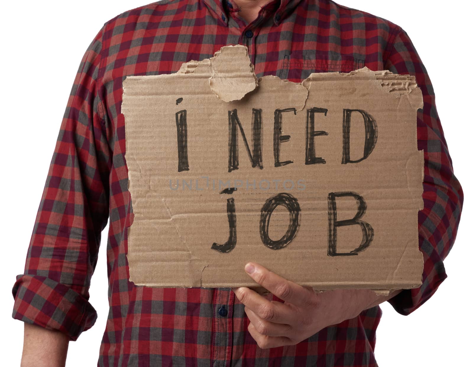 man in a plaid shirt and jeans holds a piece of paper with the inscription i need job, concept of unemployment against the backdrop of the global crisis, fired employee, man is isolated on a white