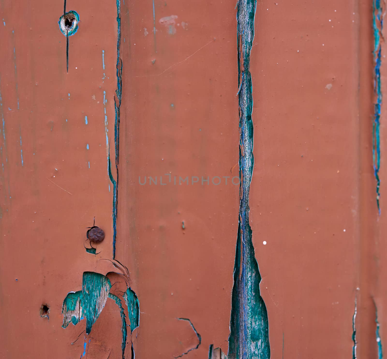 fragment of wooden board with cracked brown paint, full frame, close up