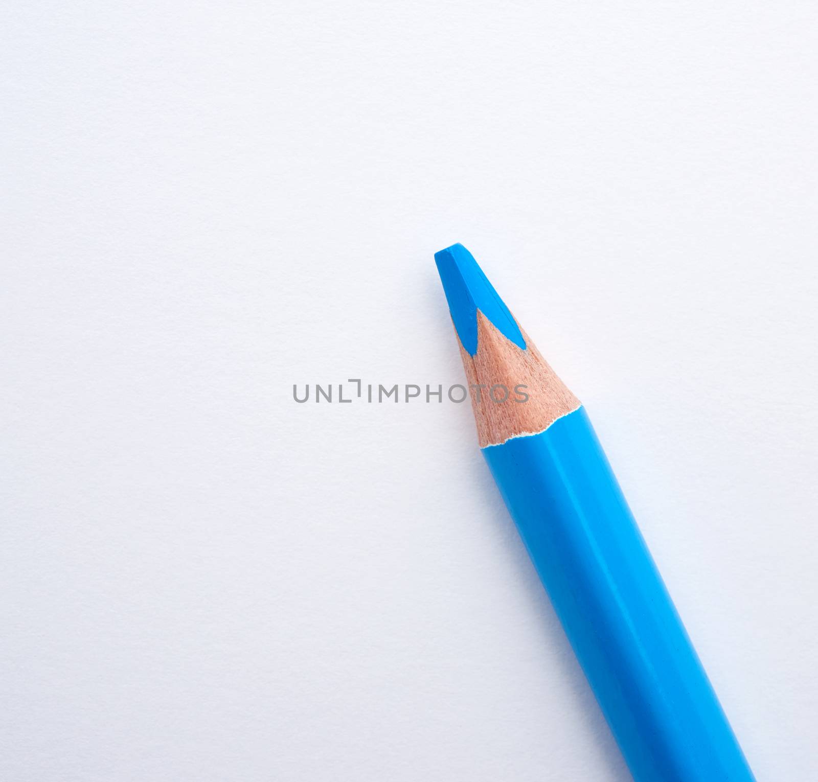 blue wooden pencil on a white background , close up