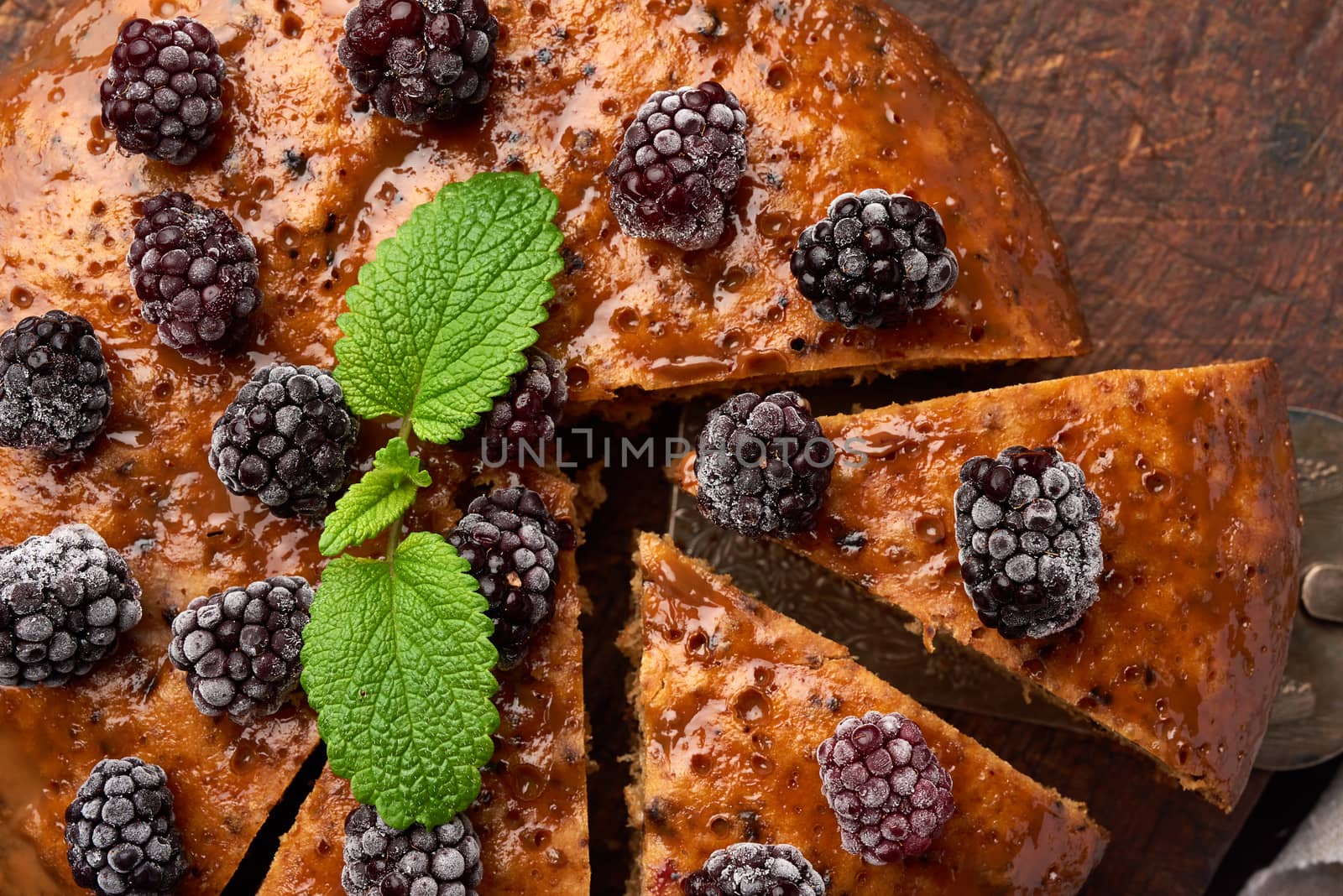 baked sweet round biscuit cake with nuts and berries topped, top view