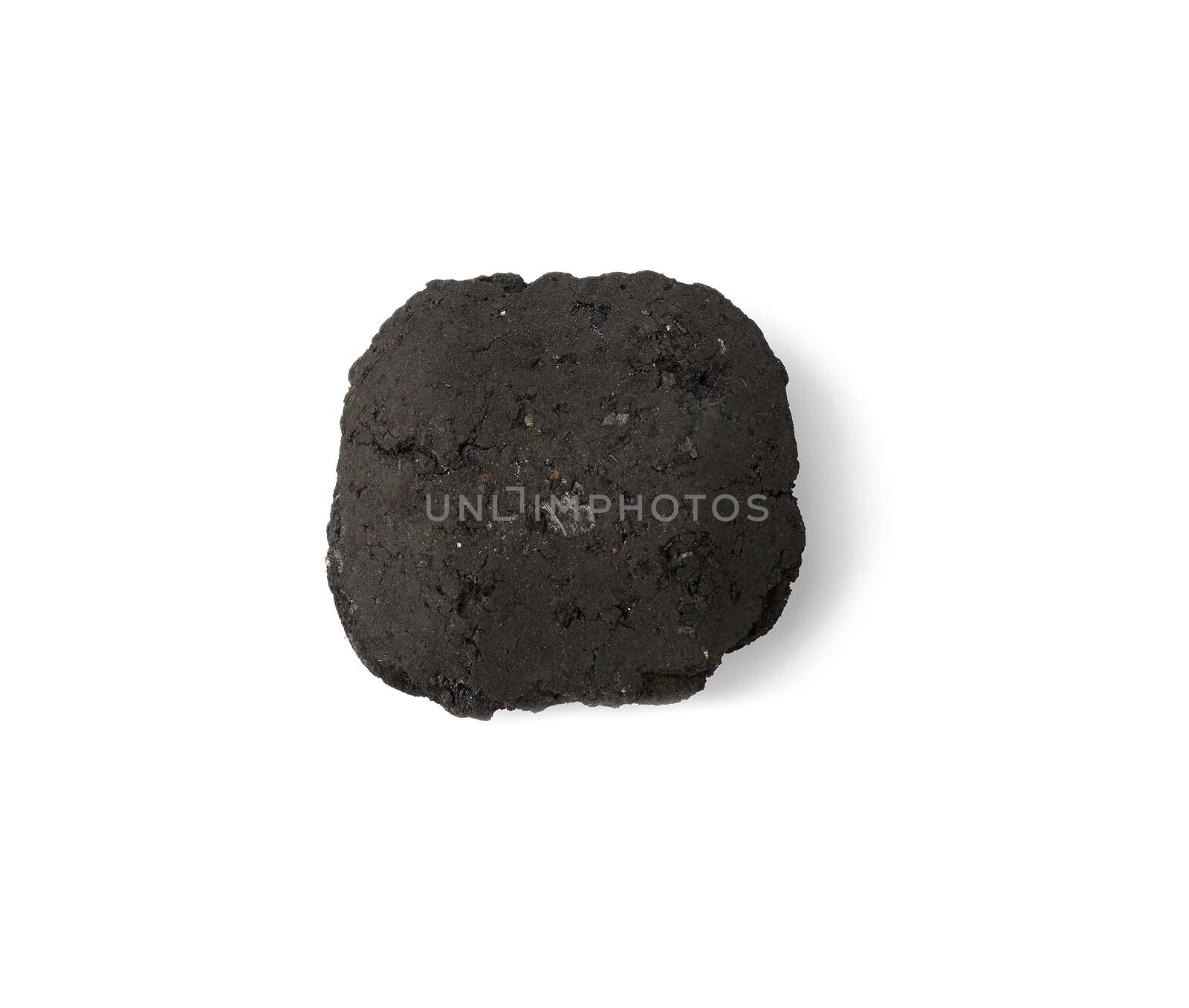 square piece of pressed charcoal for barbecue and bonfire isolated on a white background, ecological fuel