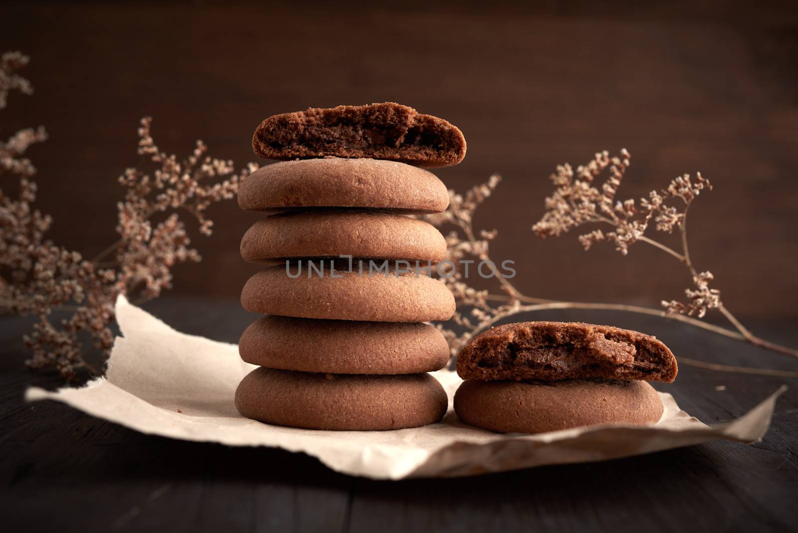 stack of round chocolate chip cookies on brown kraft paper, delicious dessert