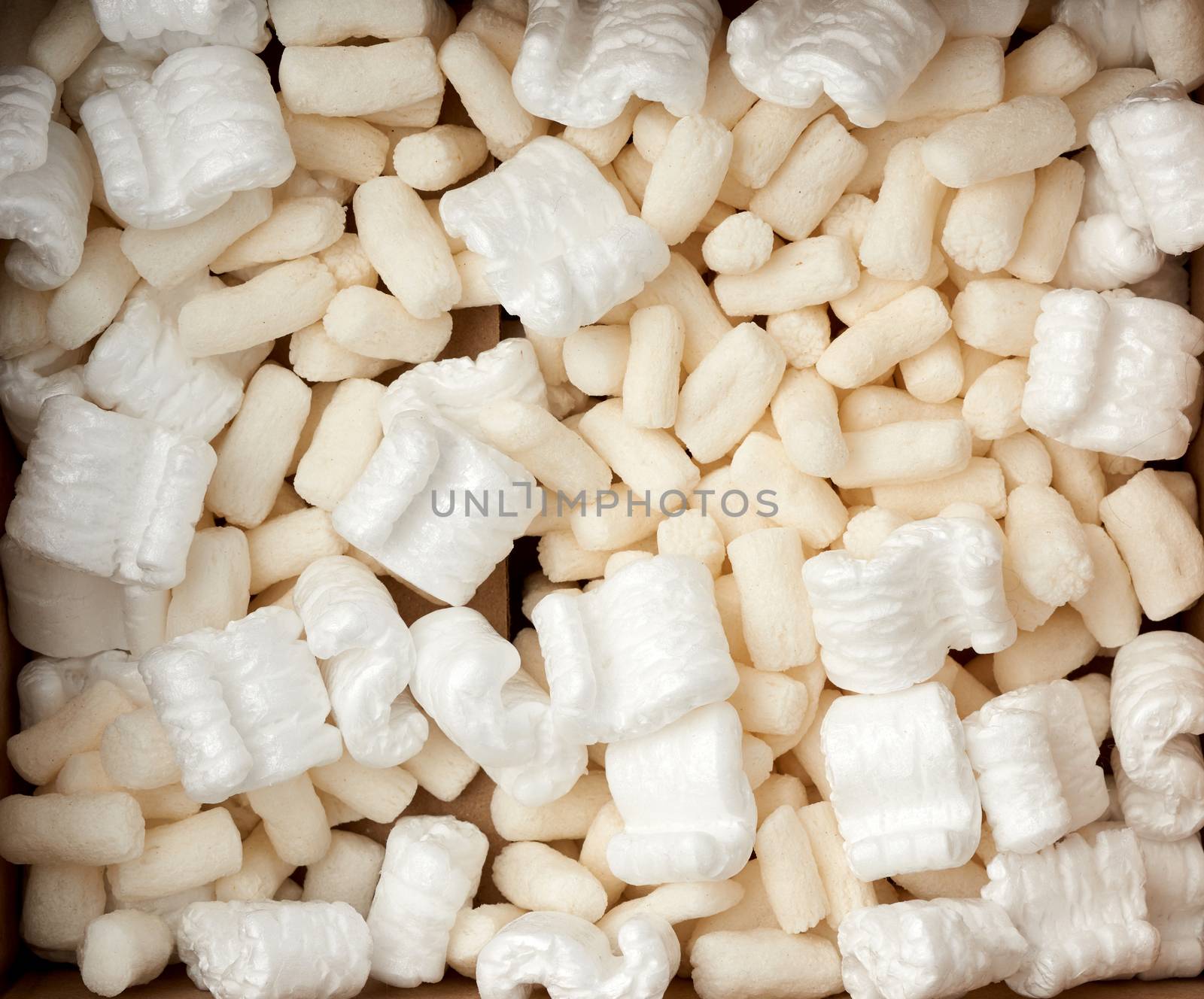 open brown cardboard box with white foam filling for transporting goods, top view
