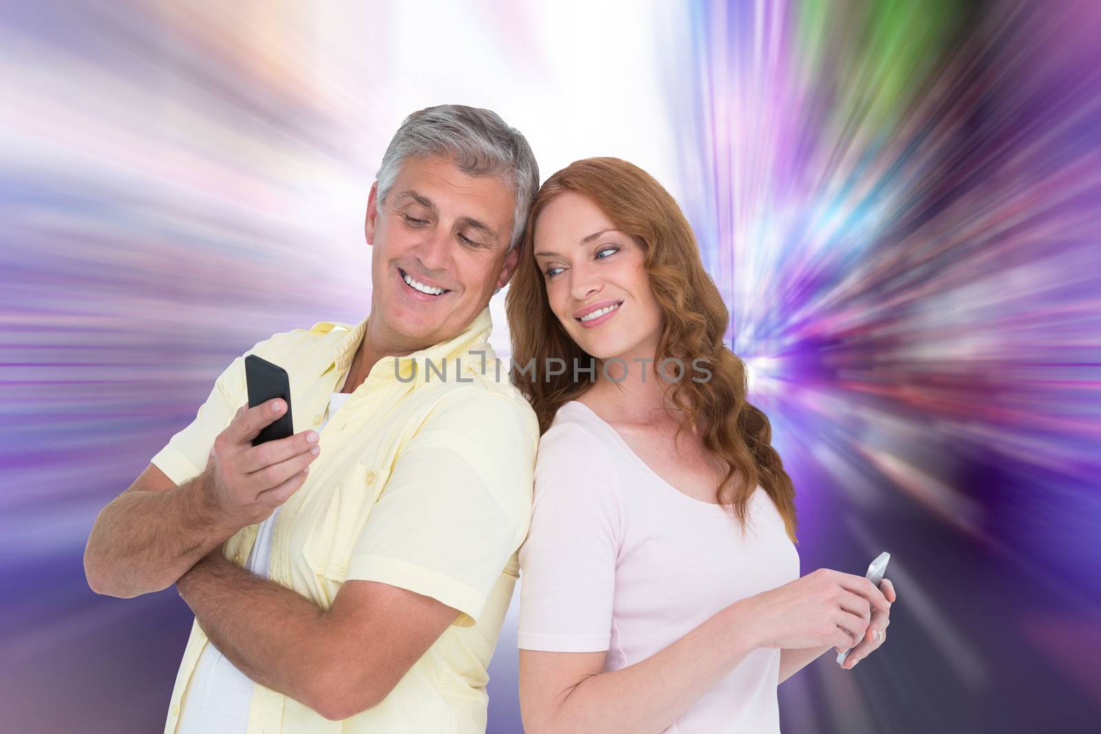 Casual couples on their phones against glittering screen in urban setting