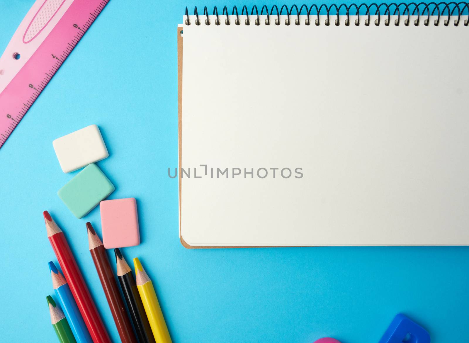 open notebook in the middle with blank white sheets, top view, concept of back to school, flat lay