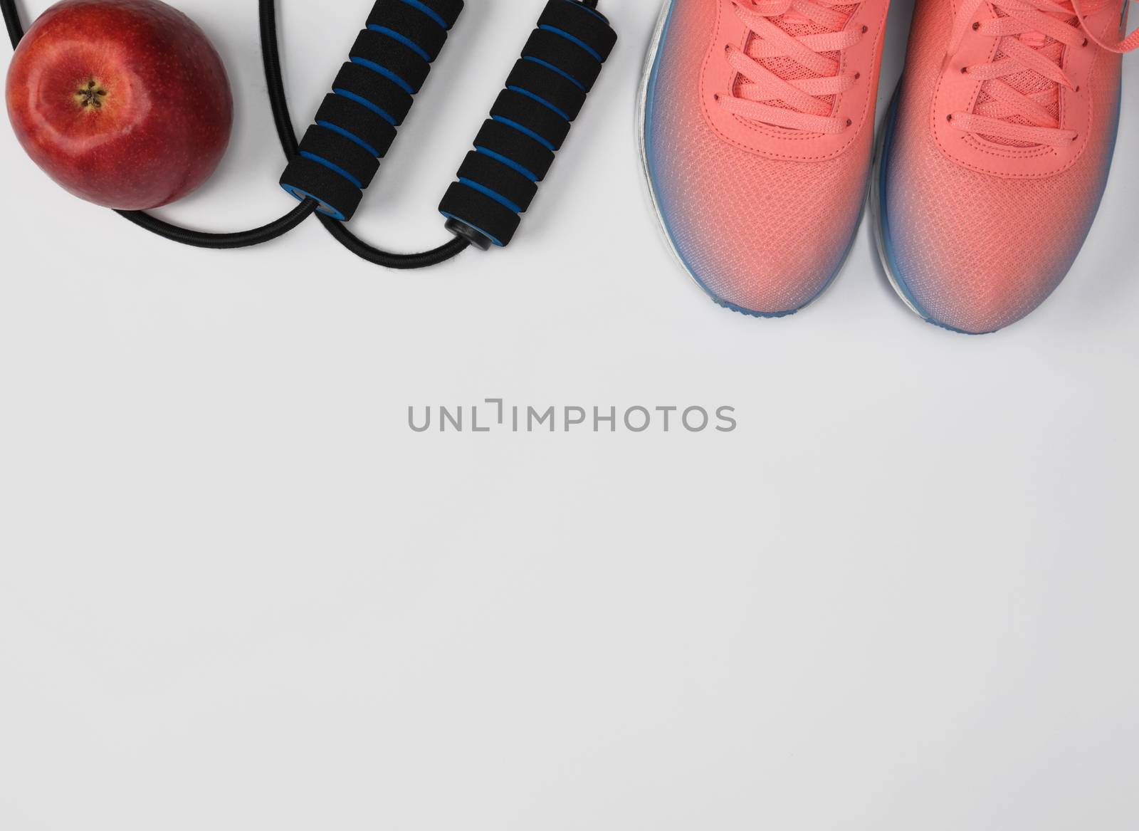 sports textile shoes and other items for fitness on a white background, top view, copy space