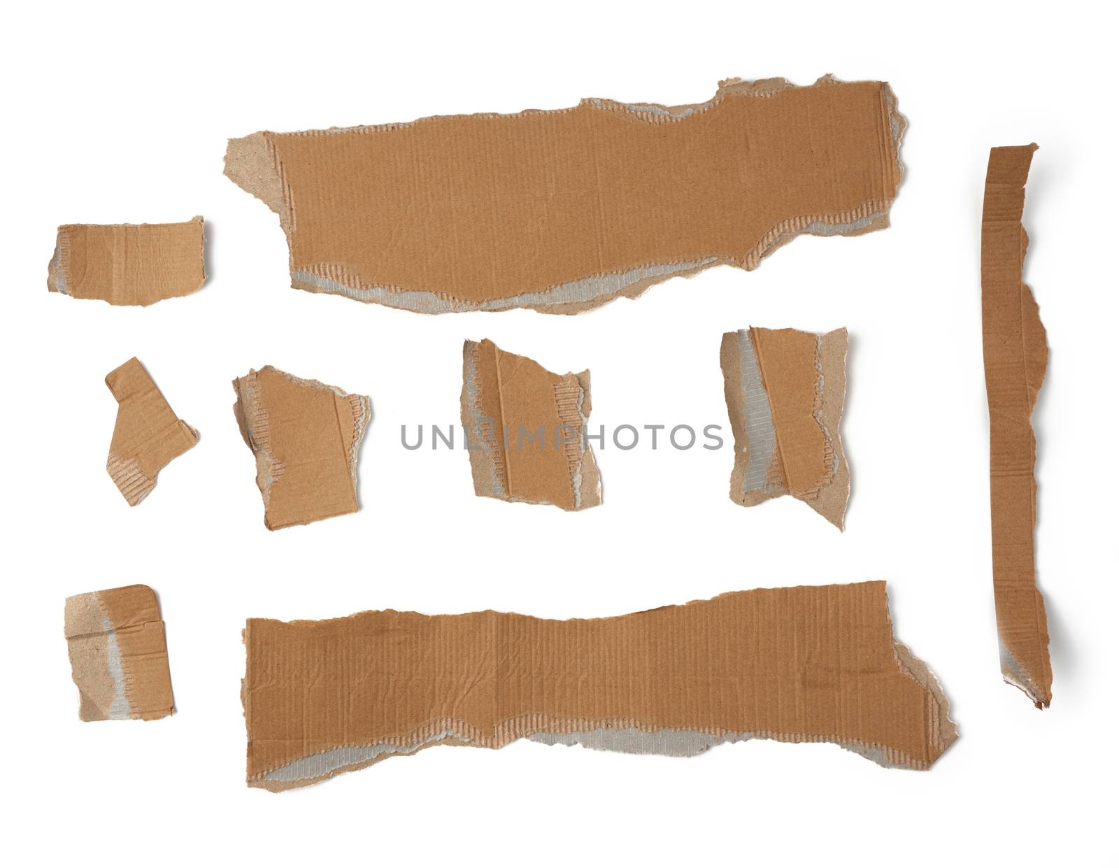 pieces of cardboard corrugated paper torn edges on a white background, abstract backdrop. Ripped paper texture