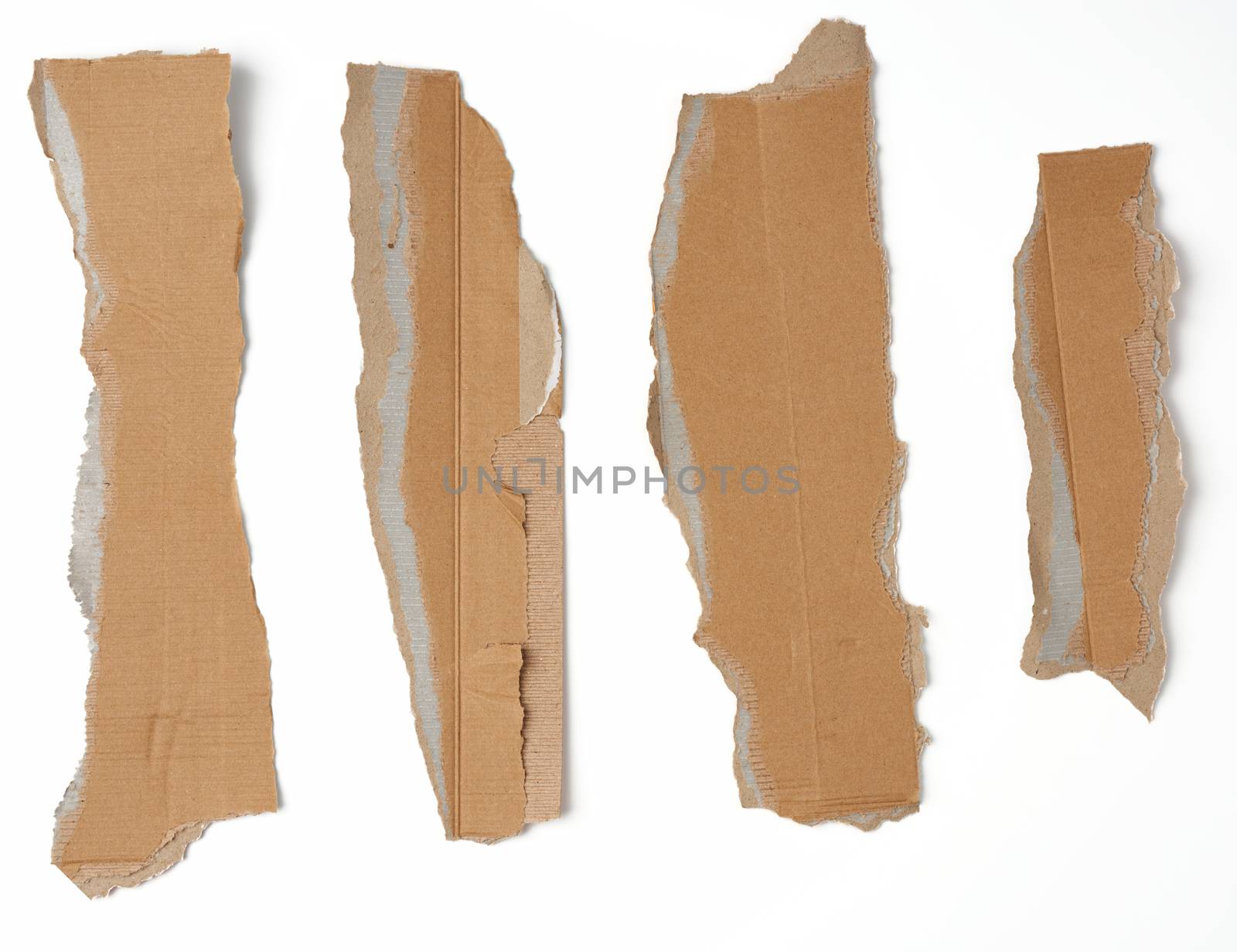 pieces of cardboard corrugated paper torn edges on a white background, abstract backdrop. Ripped paper texture.